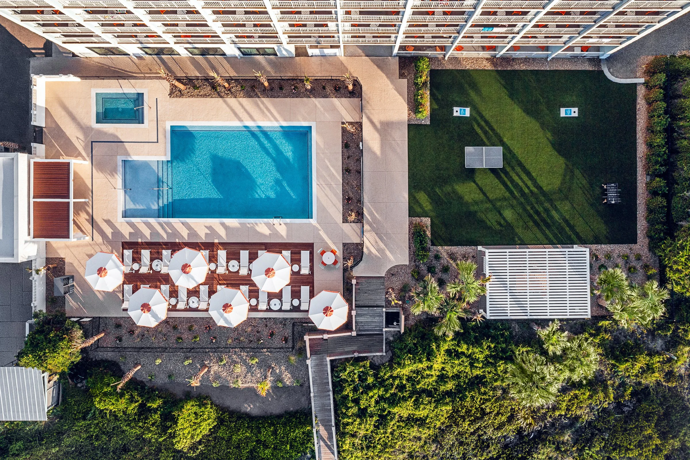 New Turf and Pool area- drone photography at Golden Sands Hotel, showing thoughtful composition, branded consistency, fun, and uncluttered guest environment. Photographed by Lange Photo Studio. 