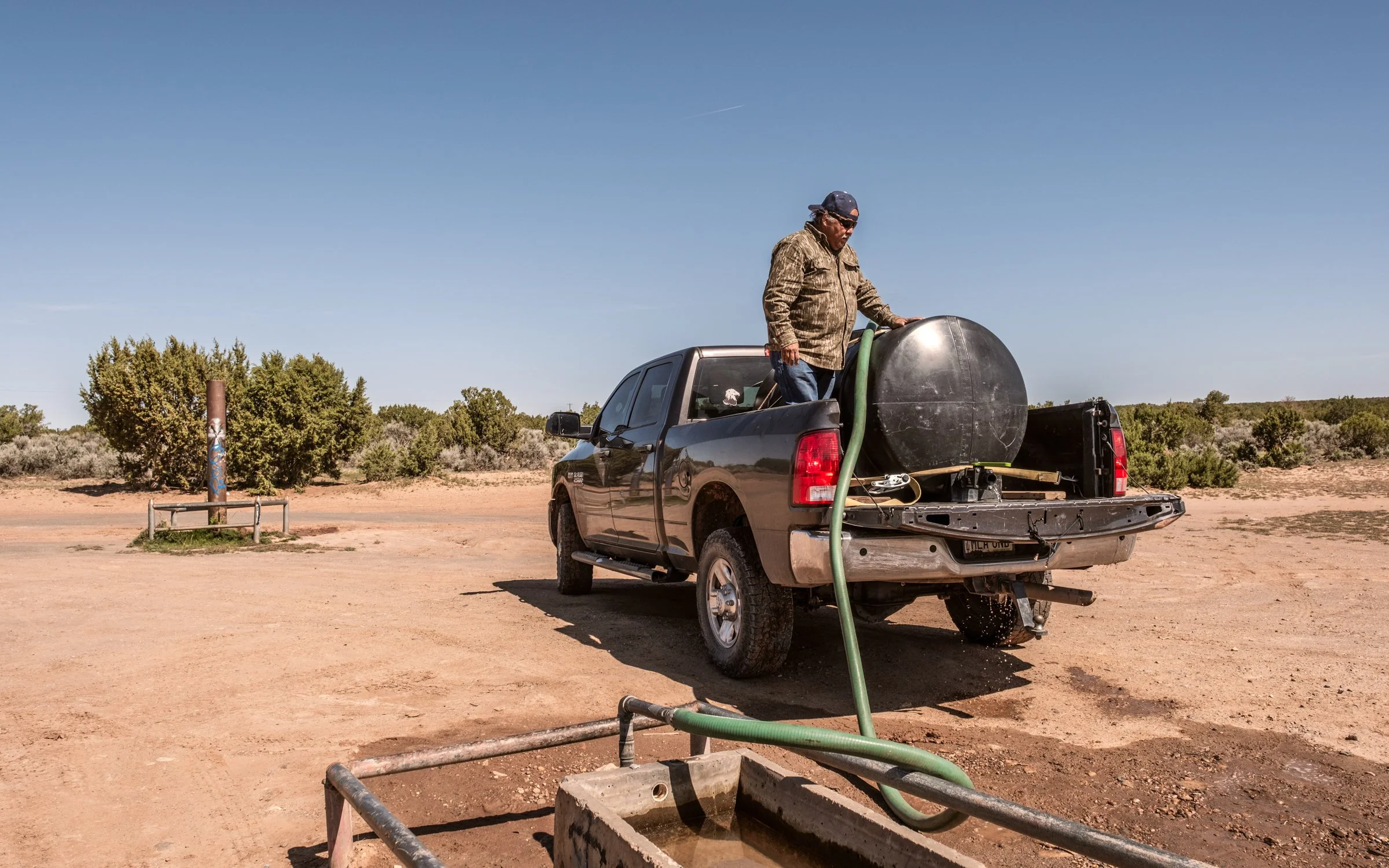 Hauling Life | Navajo Nation — Unified Metadata Paragraphs

Wayne Wilson and Joann Whiting collect water in Gallup, New Mexico at a community water source. The containers are filled, prepared, and loaded into their vehicle for transport across the Na