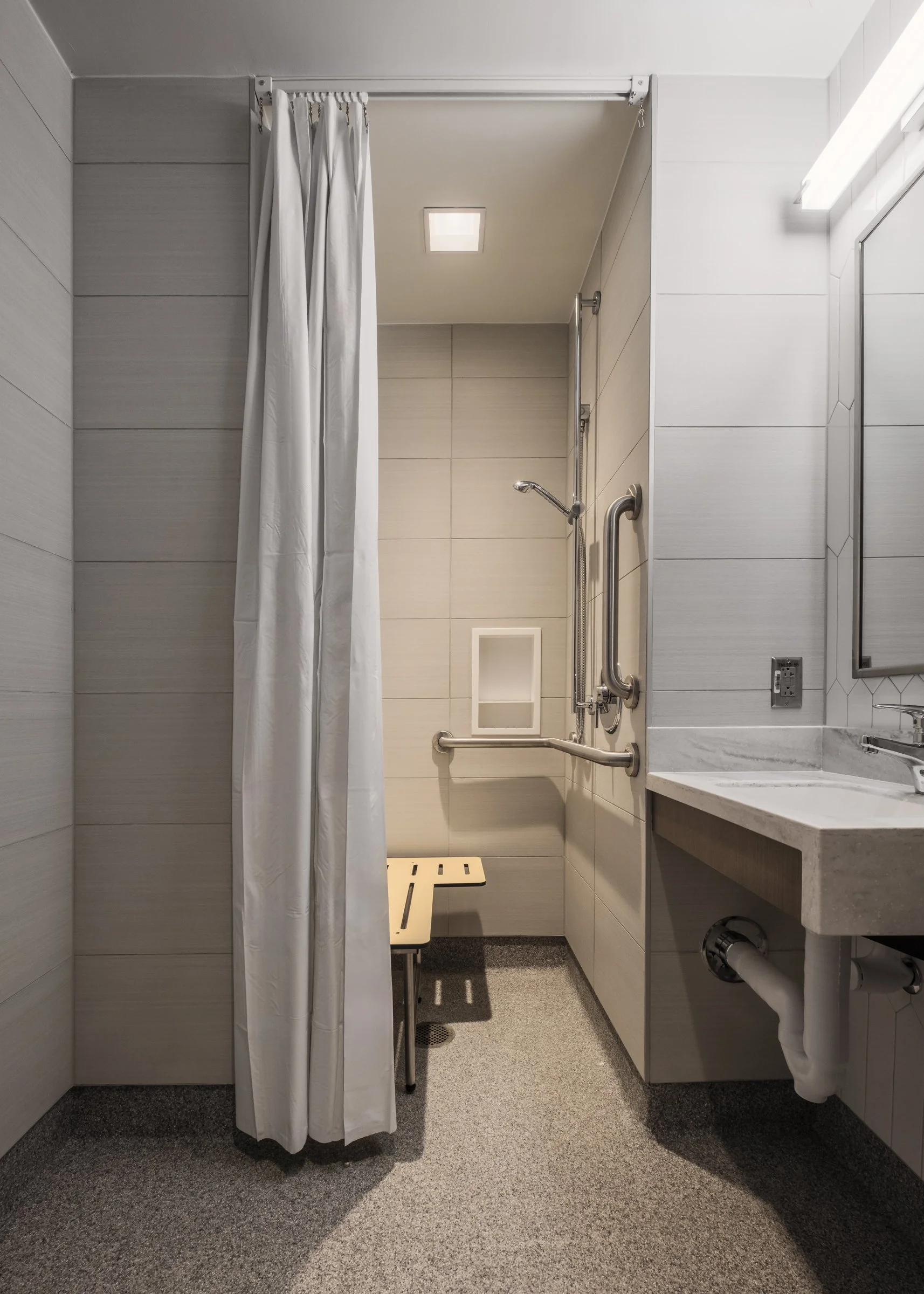 Interior view of a bathroom at Atrium Health, highlighting modern design and patient comfort.