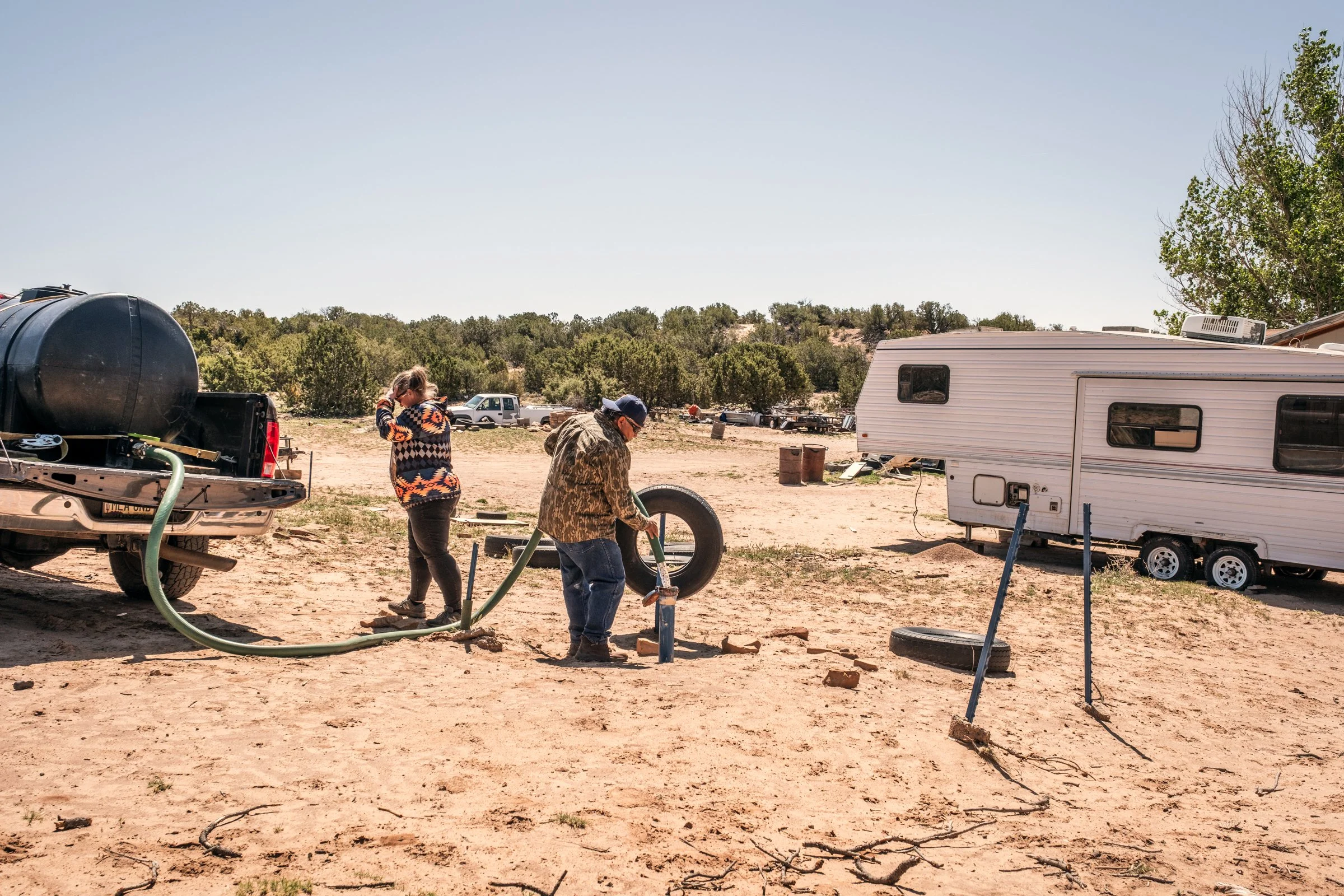 Hauling Life | Navajo Nation — Unified Metadata Paragraphs

Wayne Wilson and Joann Whiting collect water in Gallup, New Mexico at a community water source. The containers are filled, prepared, and loaded into their vehicle for transport across the Na