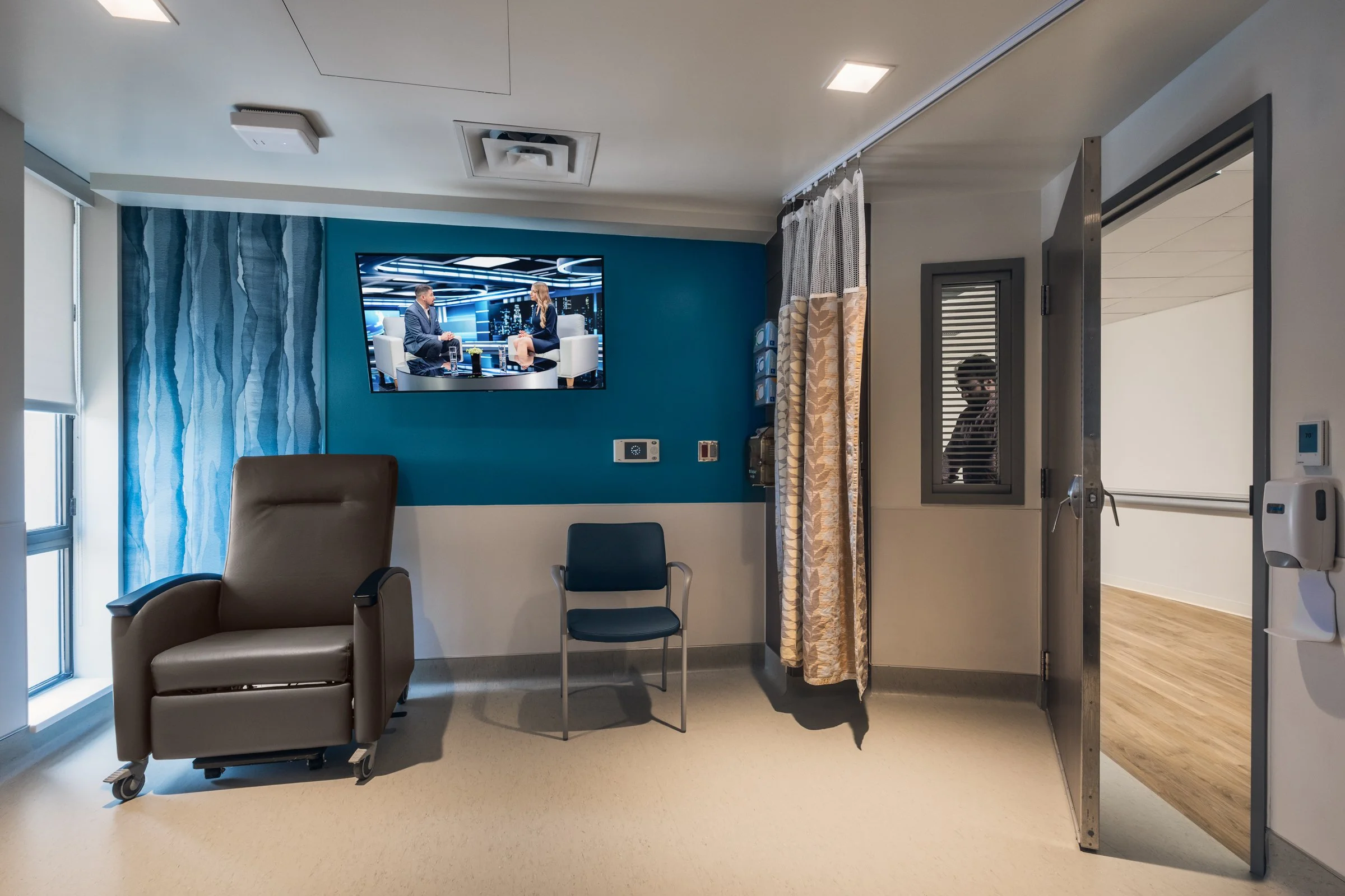 Interior view of a patient room at Atrium Health, highlighting modern design and patient comfort.