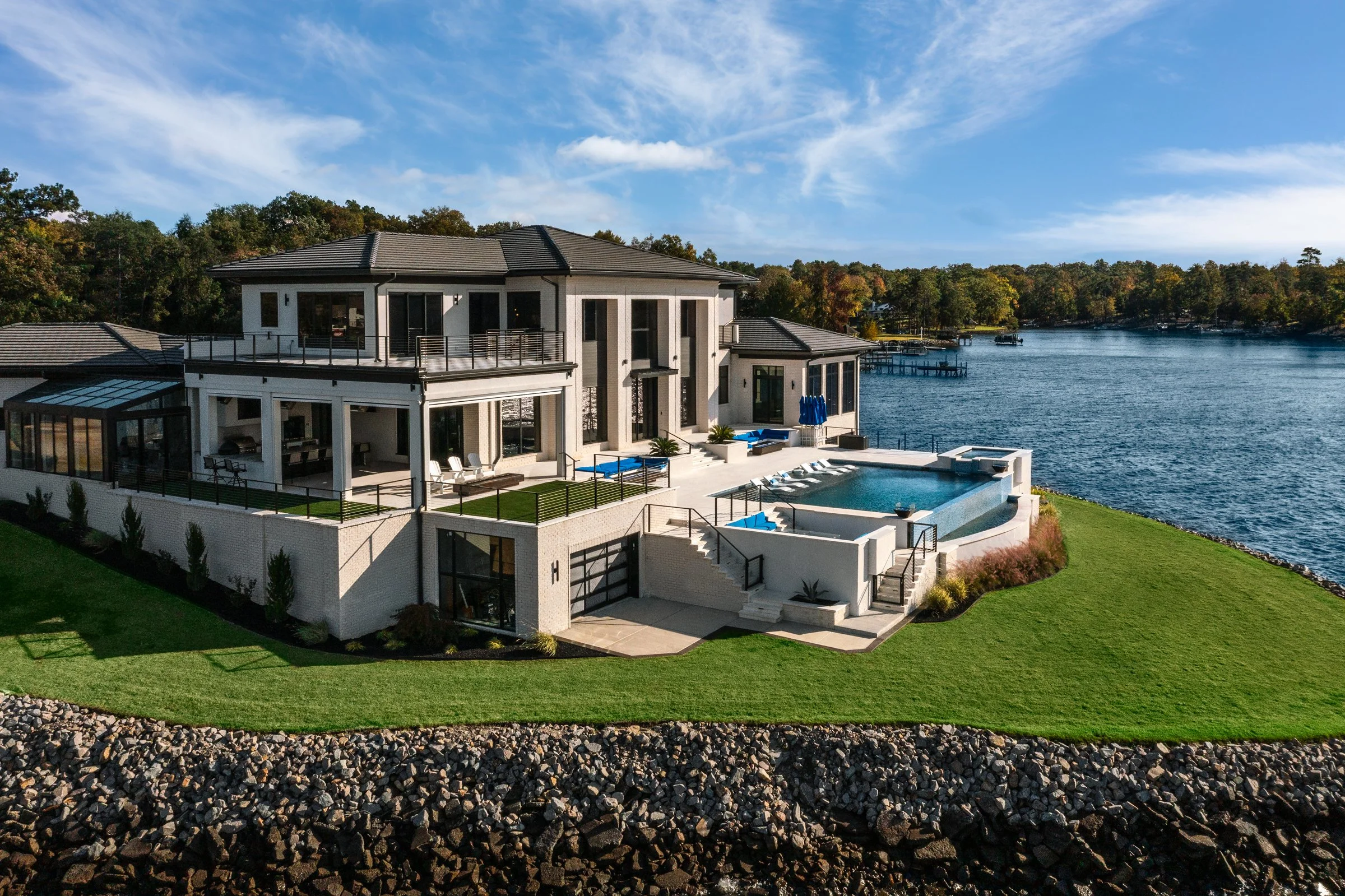 Architectural and interior photography of a customized lakefront home, highlighting design detail, atmosphere, infinity pool, and craftsmanship.