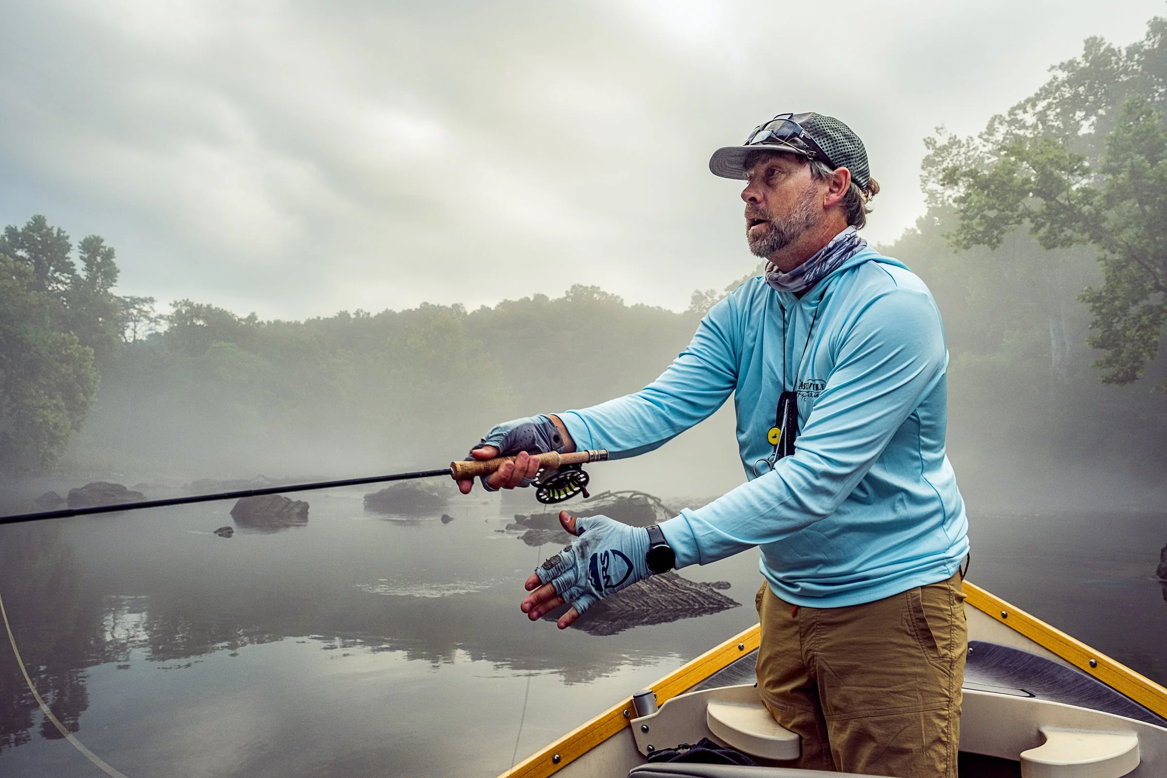 Guided fly fishing trip with Asheville Fly Fishing Company on a foggy river near Asheville, North Carolina. Photographed by Lange Photo Studio.