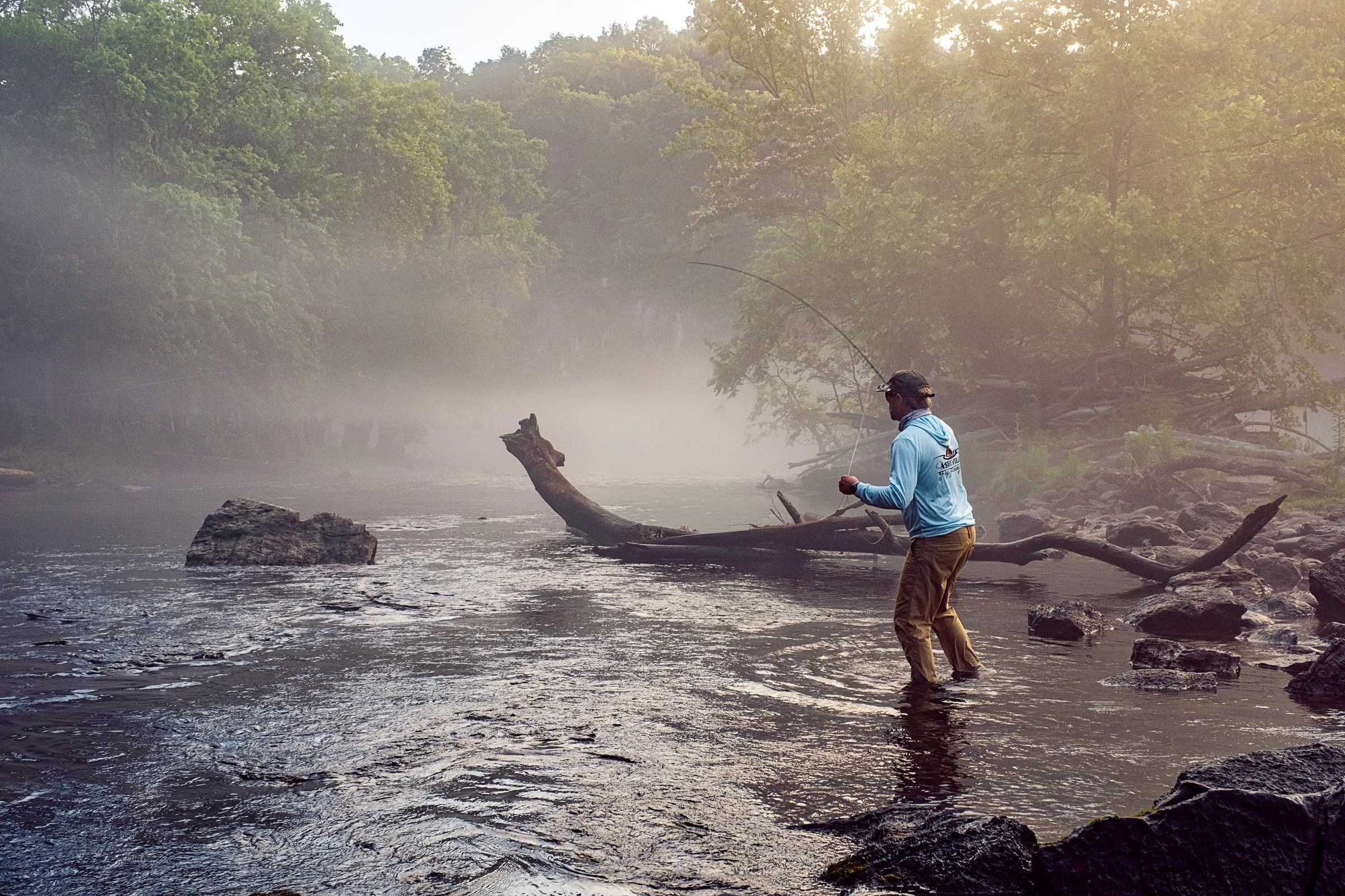 Guided fly fishing trip with Asheville Fly Fishing Company on a foggy river near Asheville, North Carolina. Photographed by Lange Photo Studio.