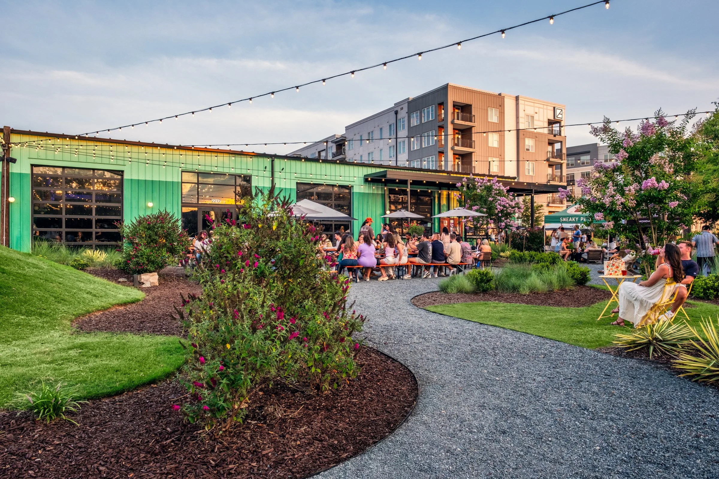 Professional photography highlighting the landscape architecture, brewery ambiance, and outdoor gathering spaces at Monday Night Brewing Charlotte.