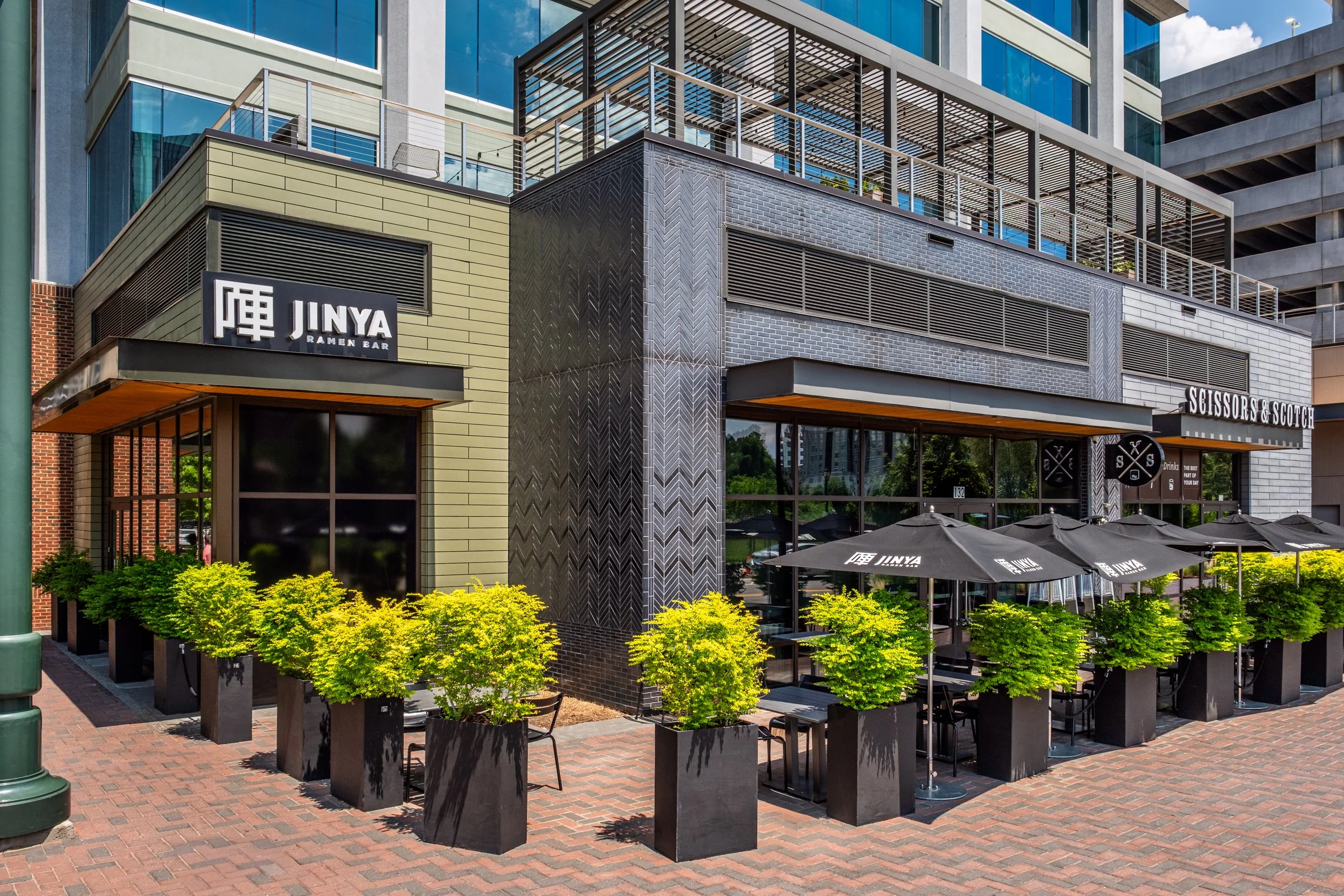 Daytime exterior view of Ally Charlotte Center, highlighting its modern architecture and urban setting in Uptown Charlotte.”