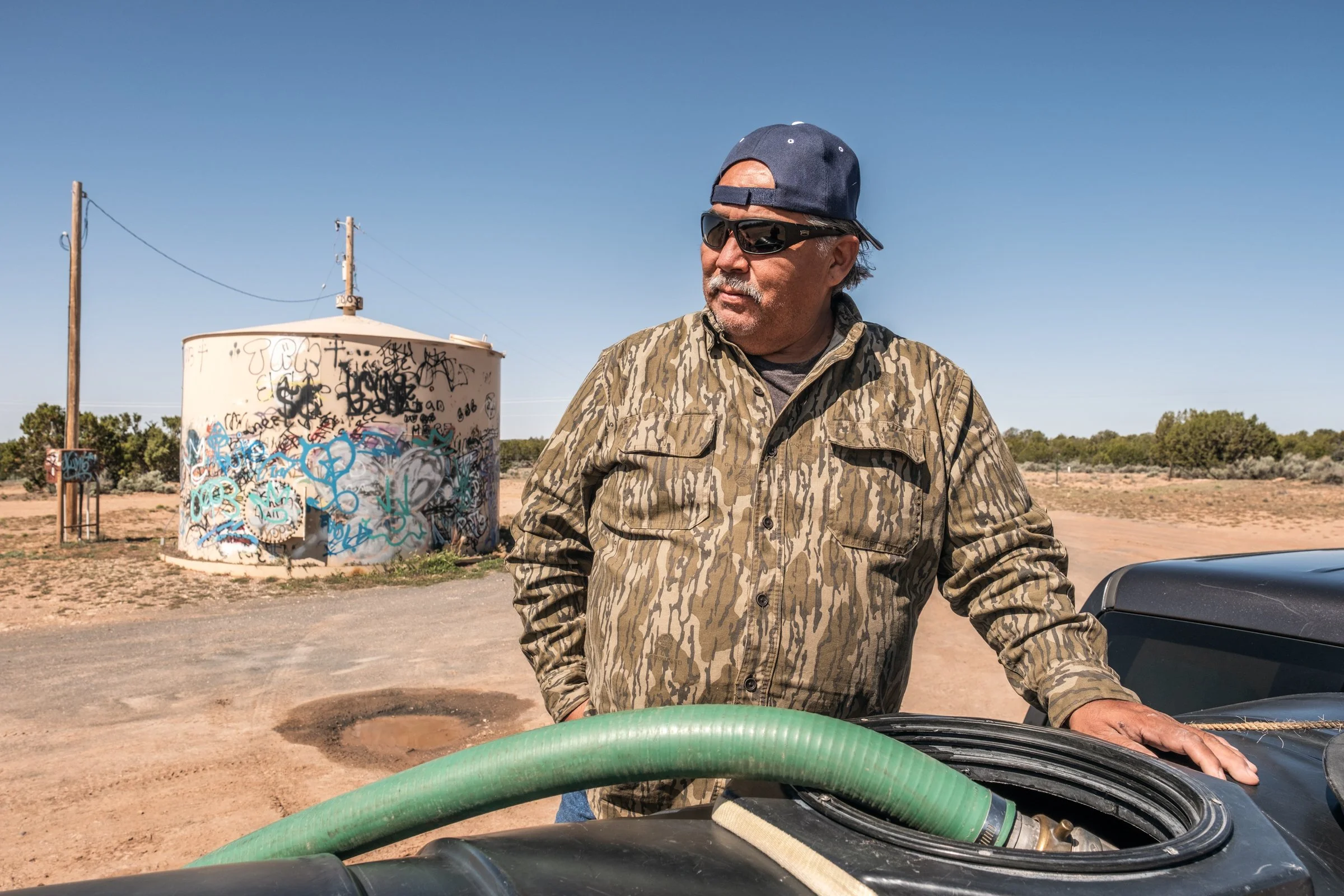 Hauling Life | Navajo Nation — Unified Metadata Paragraphs

Wayne Wilson and Joann Whiting collect water in Gallup, New Mexico at a community water source. The containers are filled, prepared, and loaded into their vehicle for transport across the Na