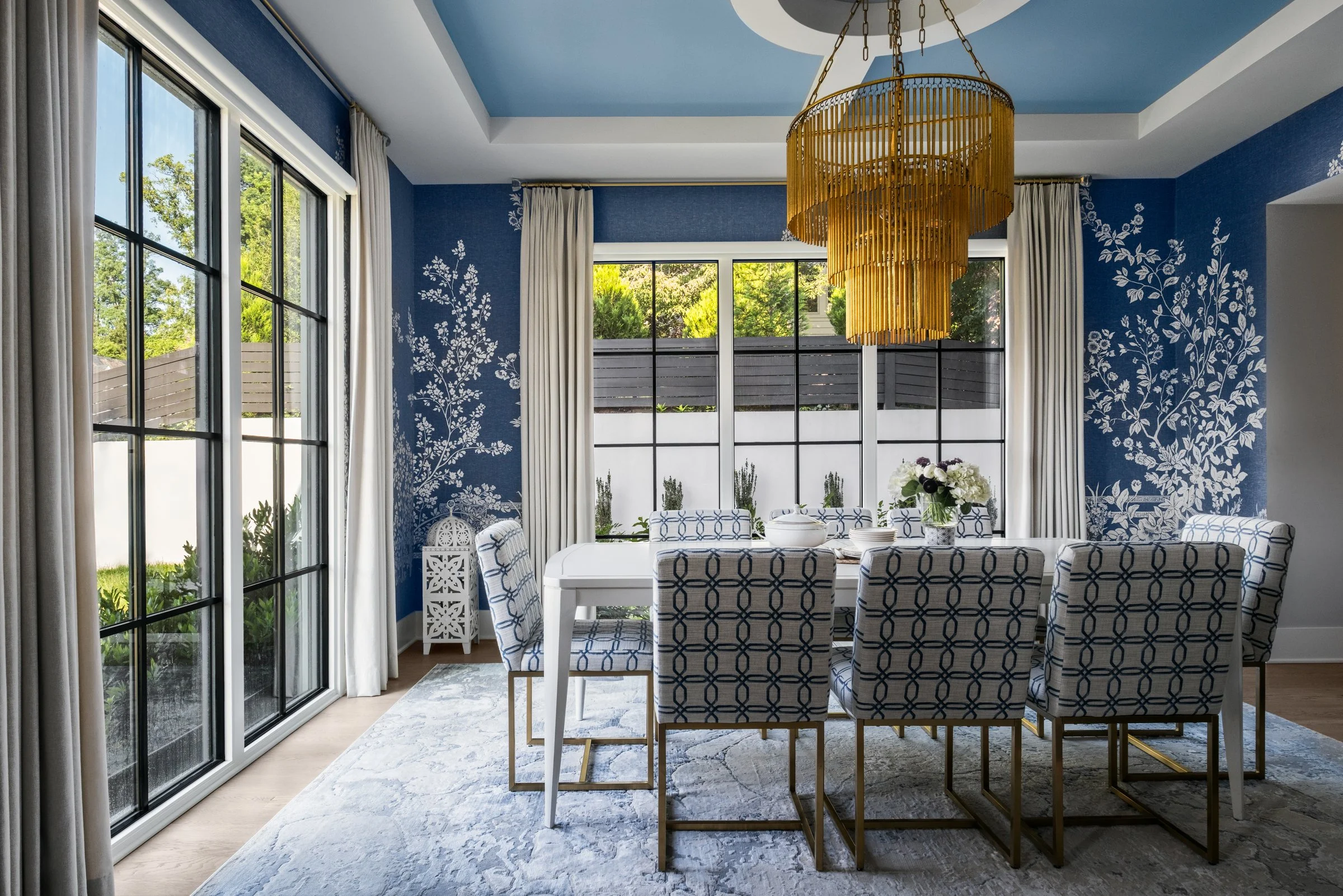 Tk.e Design showcasing a stunning dining room interior design with wall paper, photographed by Lange Photo Studio. 