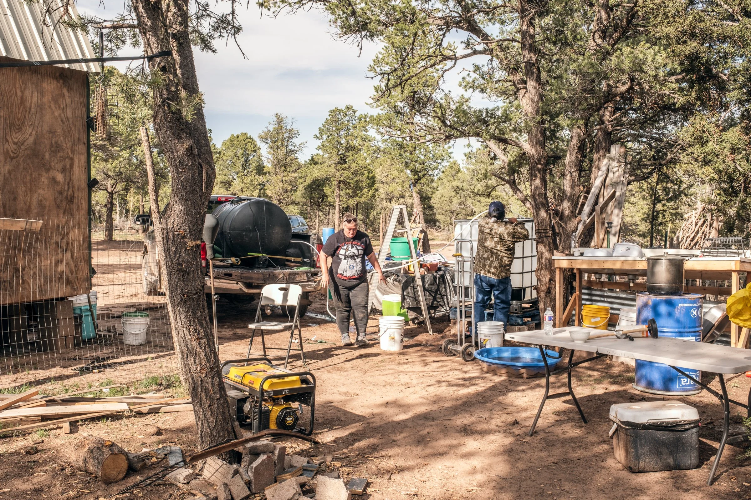 Hauling Life | Navajo Nation — Unified Metadata Paragraphs

Wayne Wilson and Joann Whiting collect water in Gallup, New Mexico at a community water source. The containers are filled, prepared, and loaded into their vehicle for transport across the Na