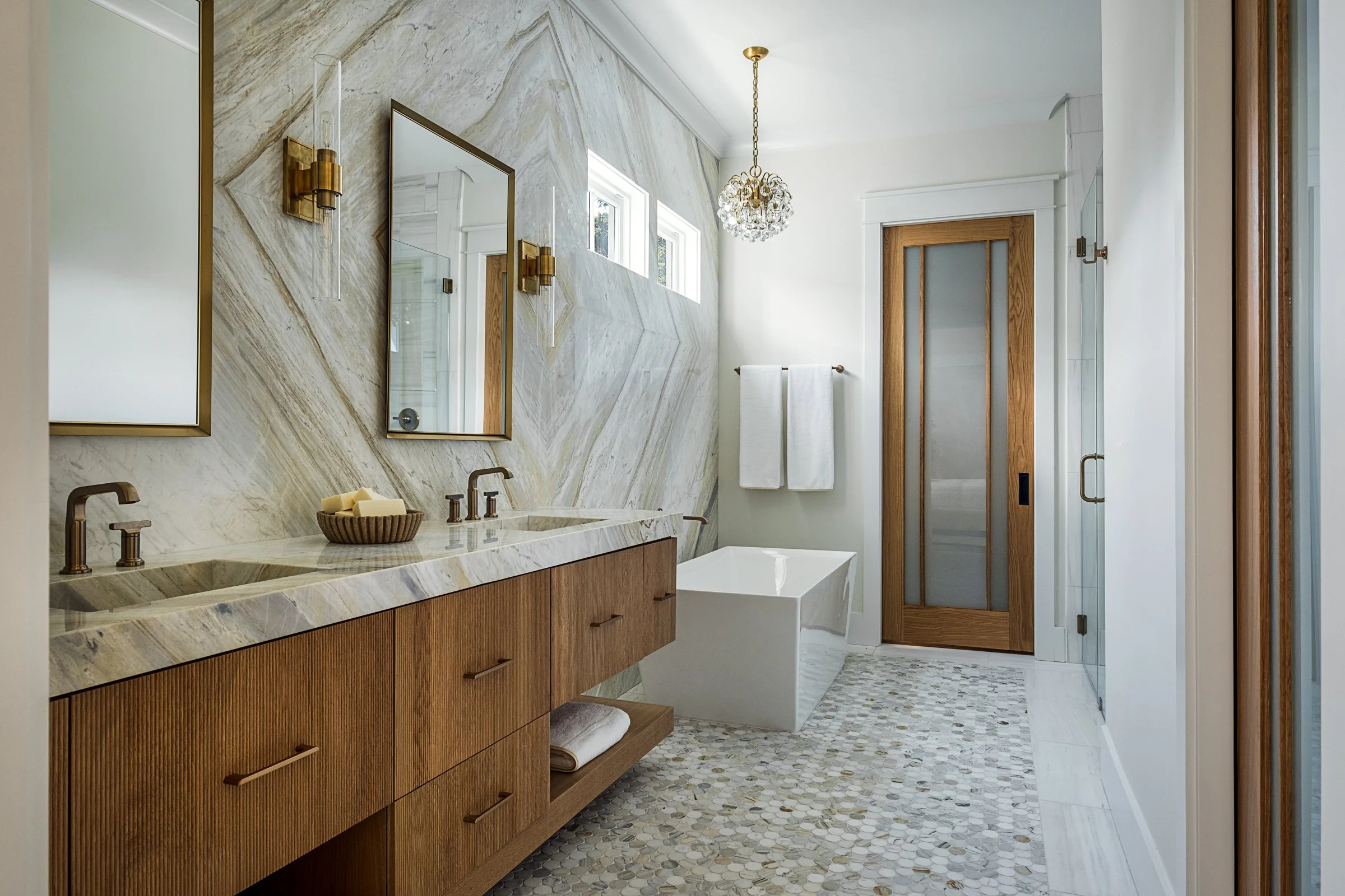 Dwelling Place Interiors luxury residential interior design project featuring a custom kitchen renovation, high-end cabinetry and millwork, detailed tilework, beautifully designed bathrooms, living spaces, bookshelves, and outdoor living areas, photo