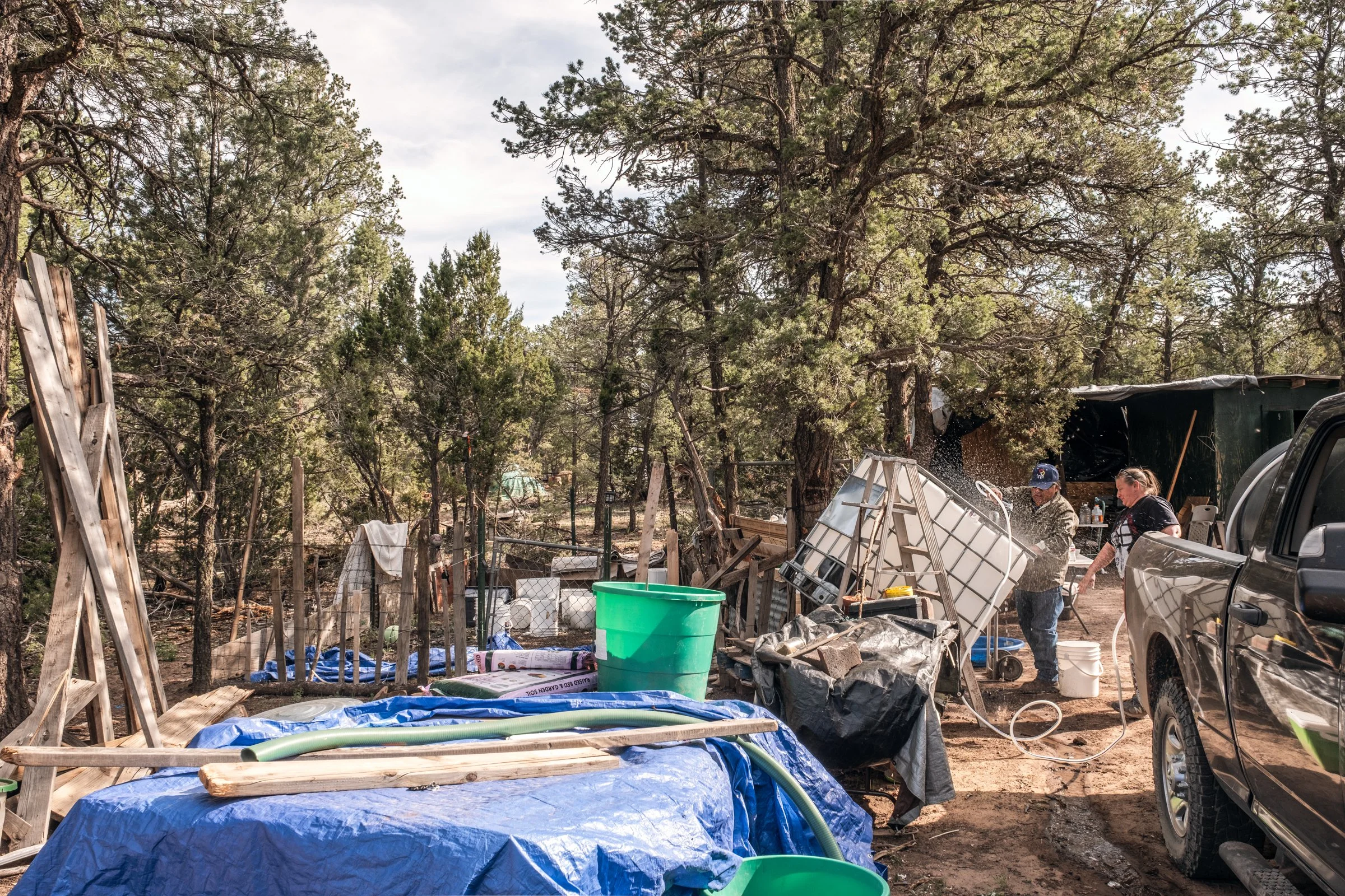 Hauling Life | Navajo Nation — Unified Metadata Paragraphs

Wayne Wilson and Joann Whiting collect water in Gallup, New Mexico at a community water source. The containers are filled, prepared, and loaded into their vehicle for transport across the Na