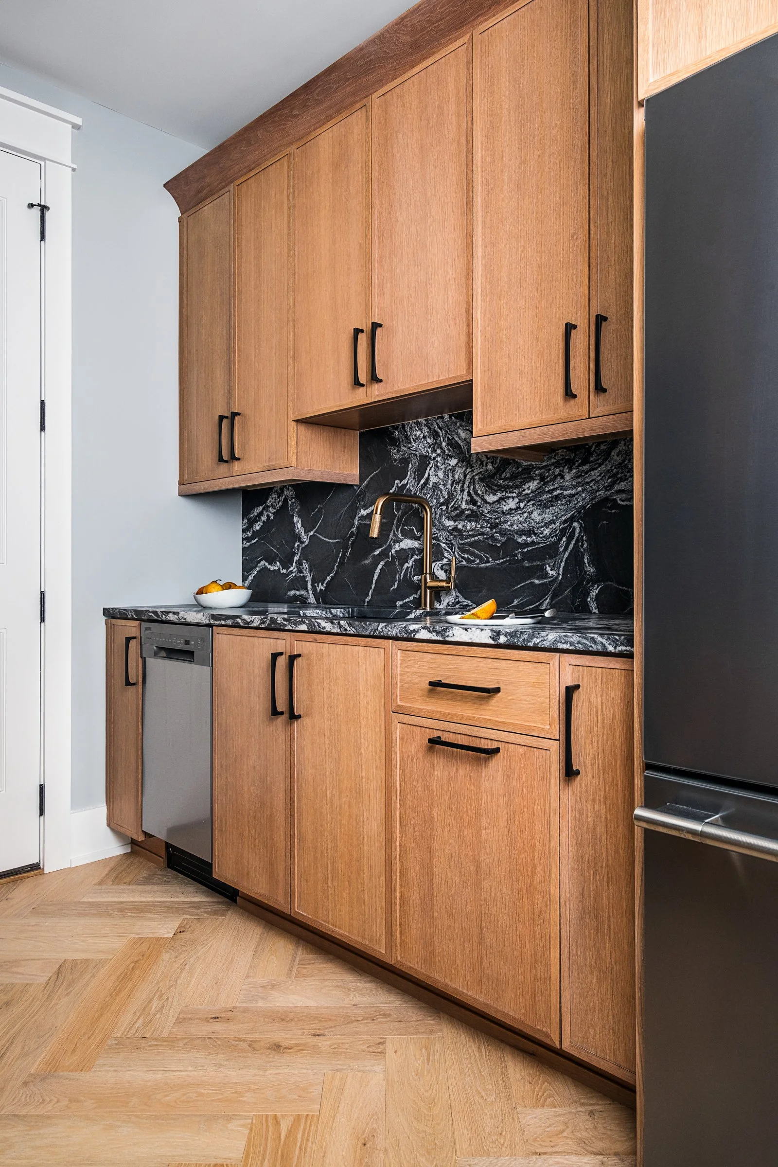 Dwelling Place Interiors luxury residential interior design project featuring a custom kitchen renovation, high-end cabinetry and millwork, detailed tilework, beautifully designed bathrooms, living spaces, bookshelves, and outdoor living areas, photo