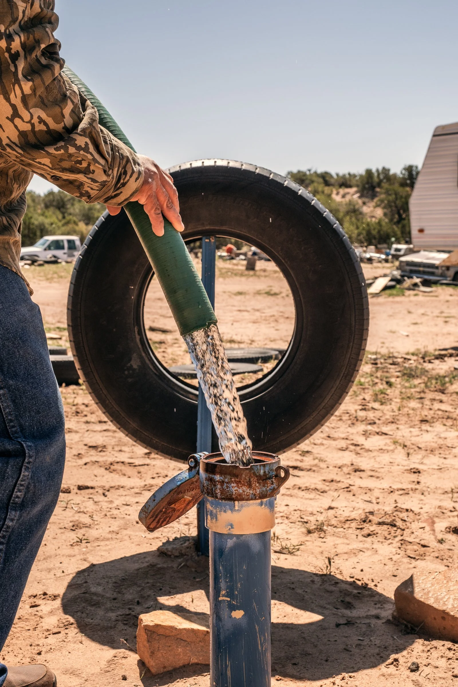 Hauling Life | Navajo Nation — Unified Metadata Paragraphs

Wayne Wilson and Joann Whiting collect water in Gallup, New Mexico at a community water source. The containers are filled, prepared, and loaded into their vehicle for transport across the Na