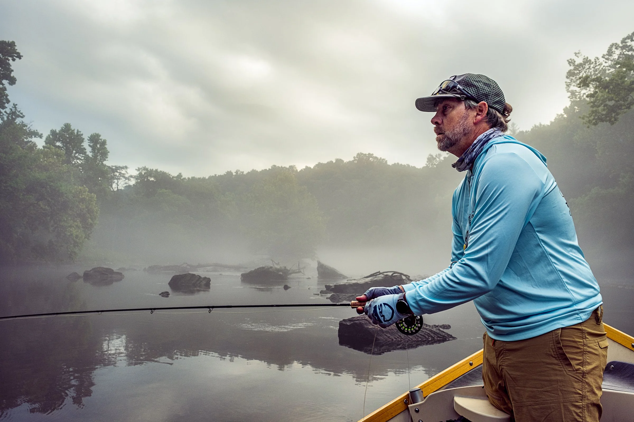 Guided fly fishing trip with Asheville Fly Fishing Company on a foggy river near Asheville, North Carolina. Photographed by Lange Photo Studio.