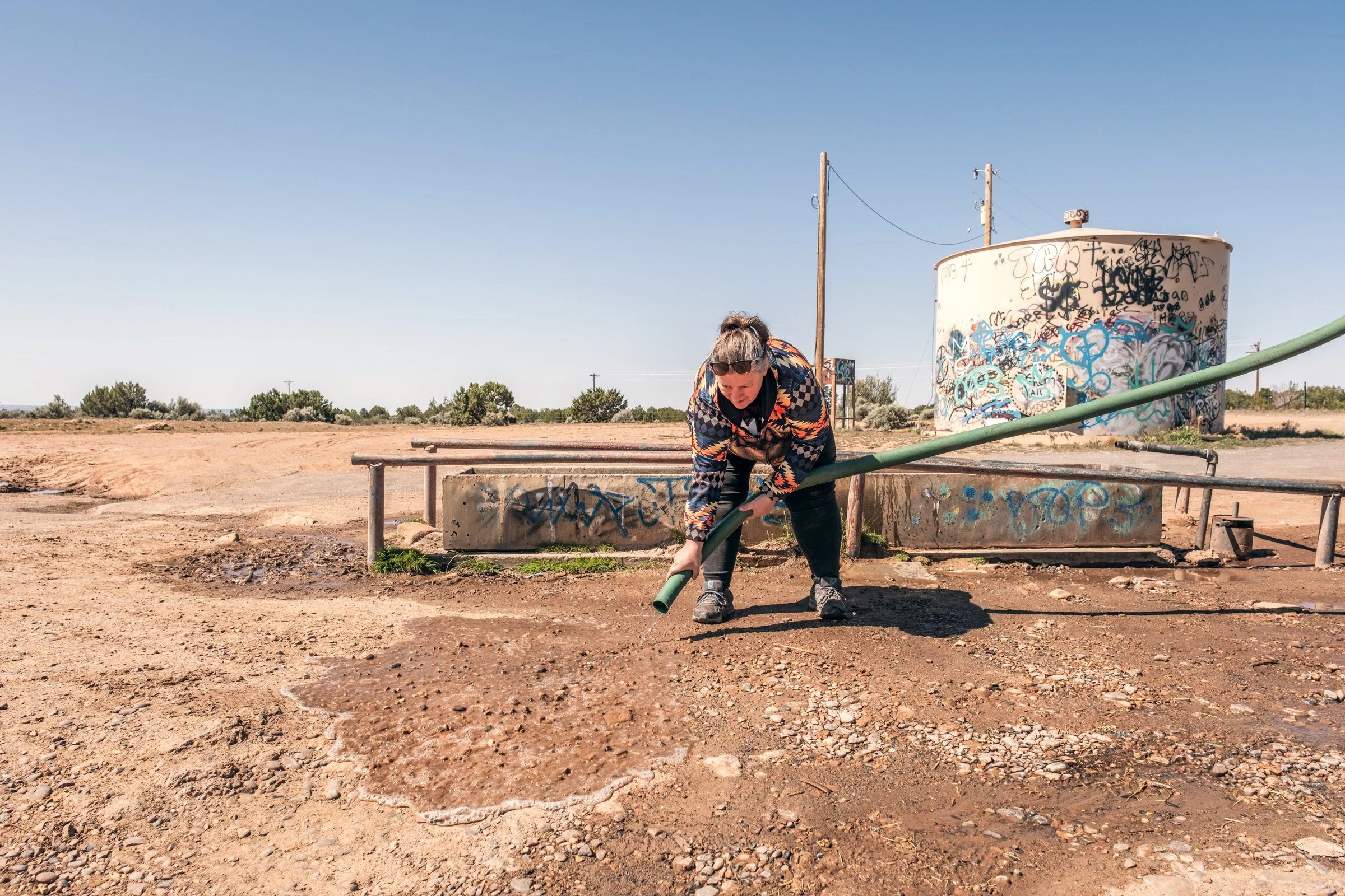 Wayne Wilson and Joann Whiting collect water in Gallup, New Mexico at a community water source. The containers are filled, prepared, and loaded into their vehicle for transport across the Navajo Nation.

They depart on a long route through the desert