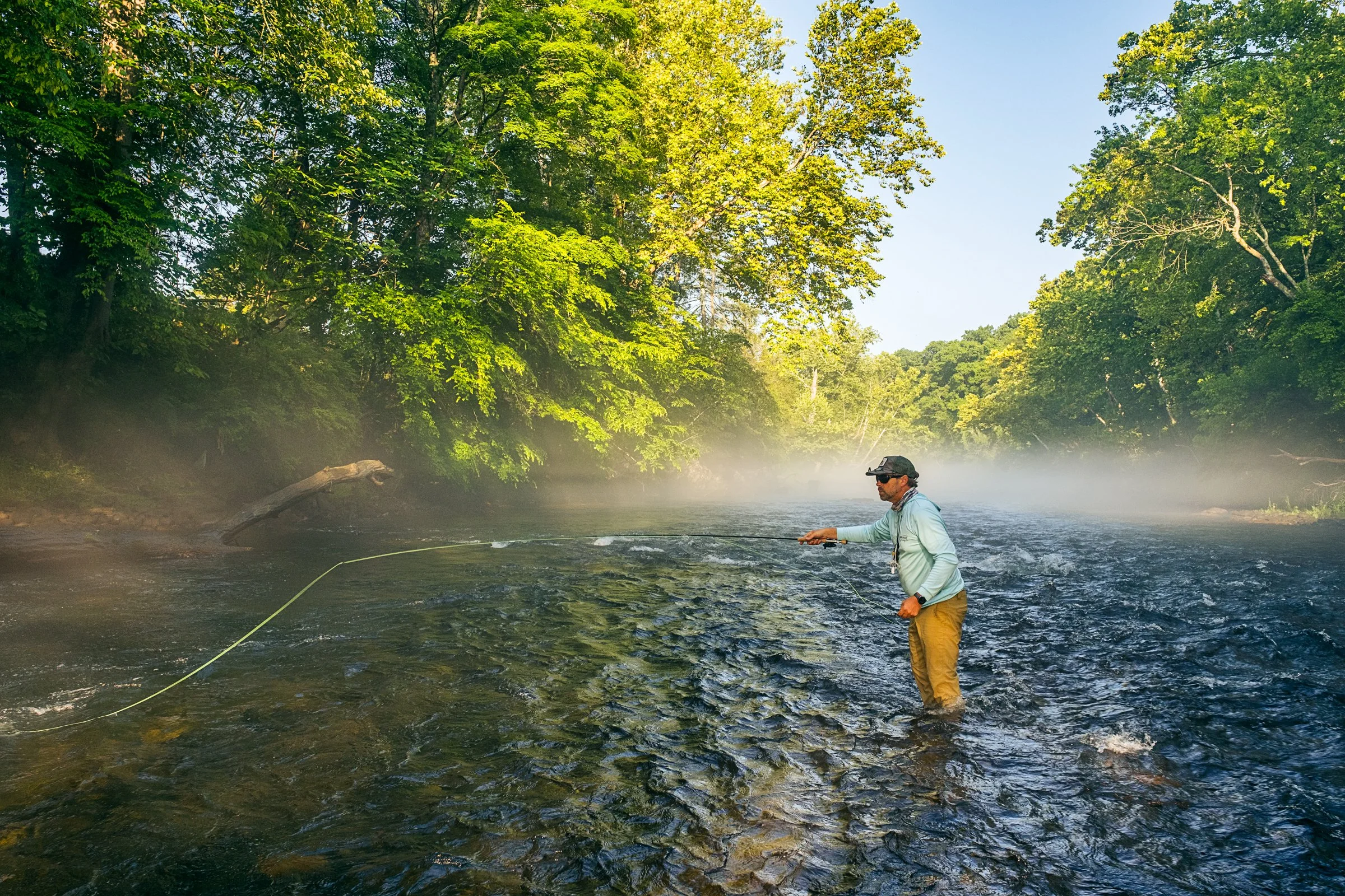 Guided fly fishing trip with Asheville Fly Fishing Company on a foggy river near Asheville, North Carolina. Photographed by Lange Photo Studio.