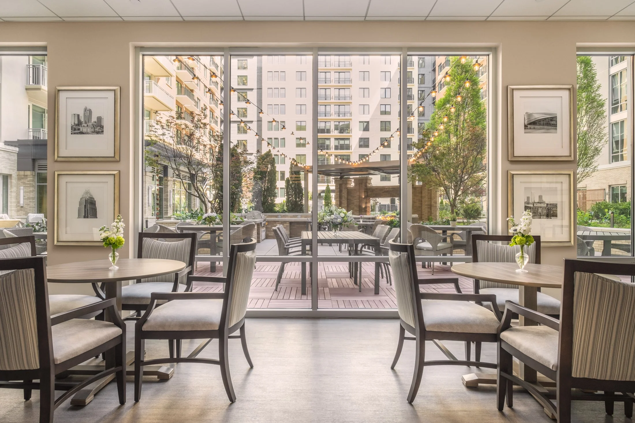 Ground-level perspective of Village on Morehead's architectural details with curved glass entrance and pedestrian walkway