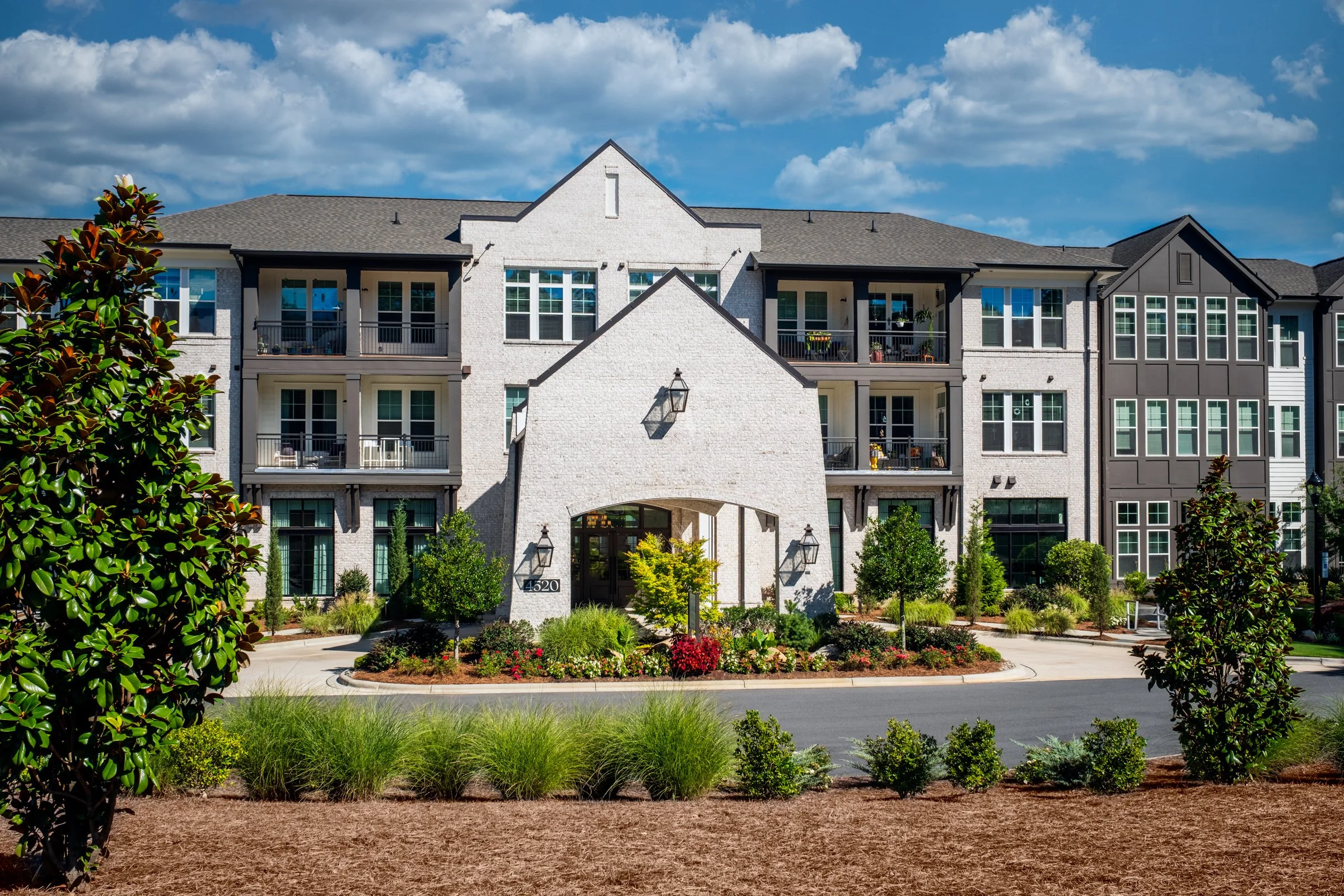 Connery on Providence 55+ community pool and adjacent amenity space, showcasing photography landscape design and seating areas, Charlotte, NC. Created by Lange Photo Studio. 