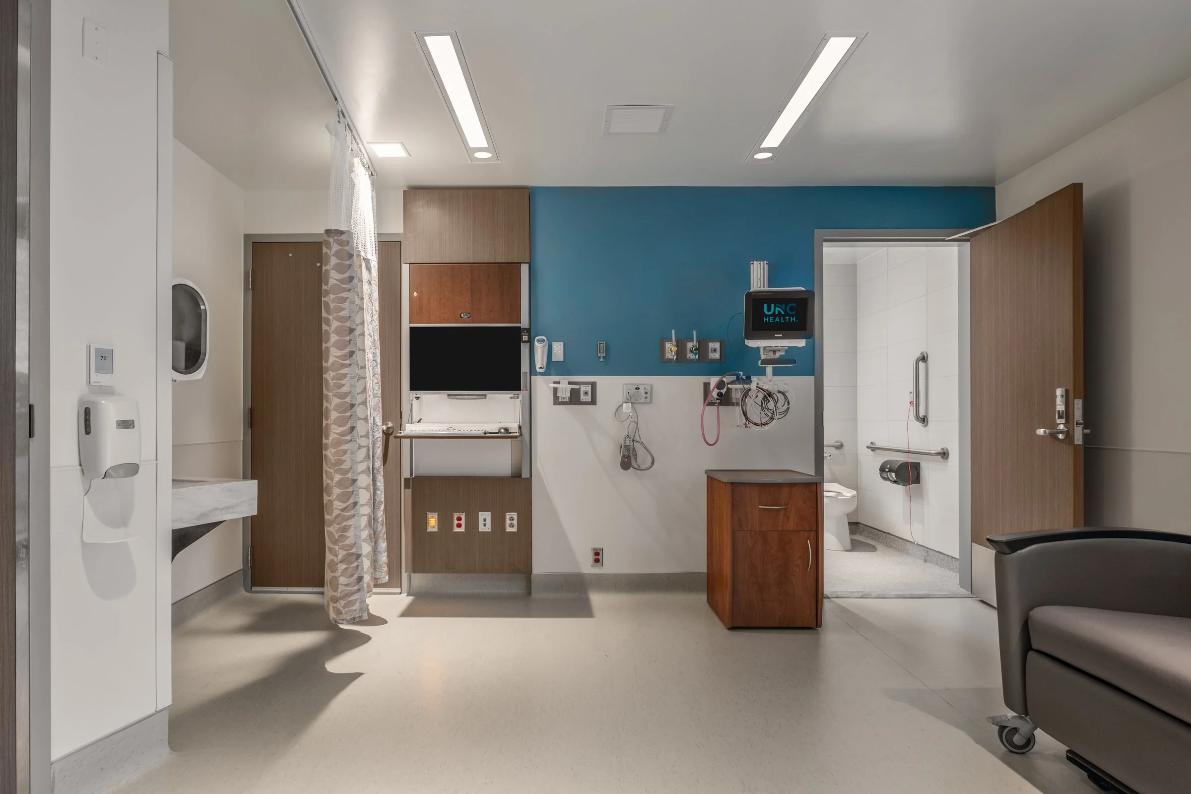 Interior view of a patient room at Atrium Health, highlighting modern design and patient comfort.