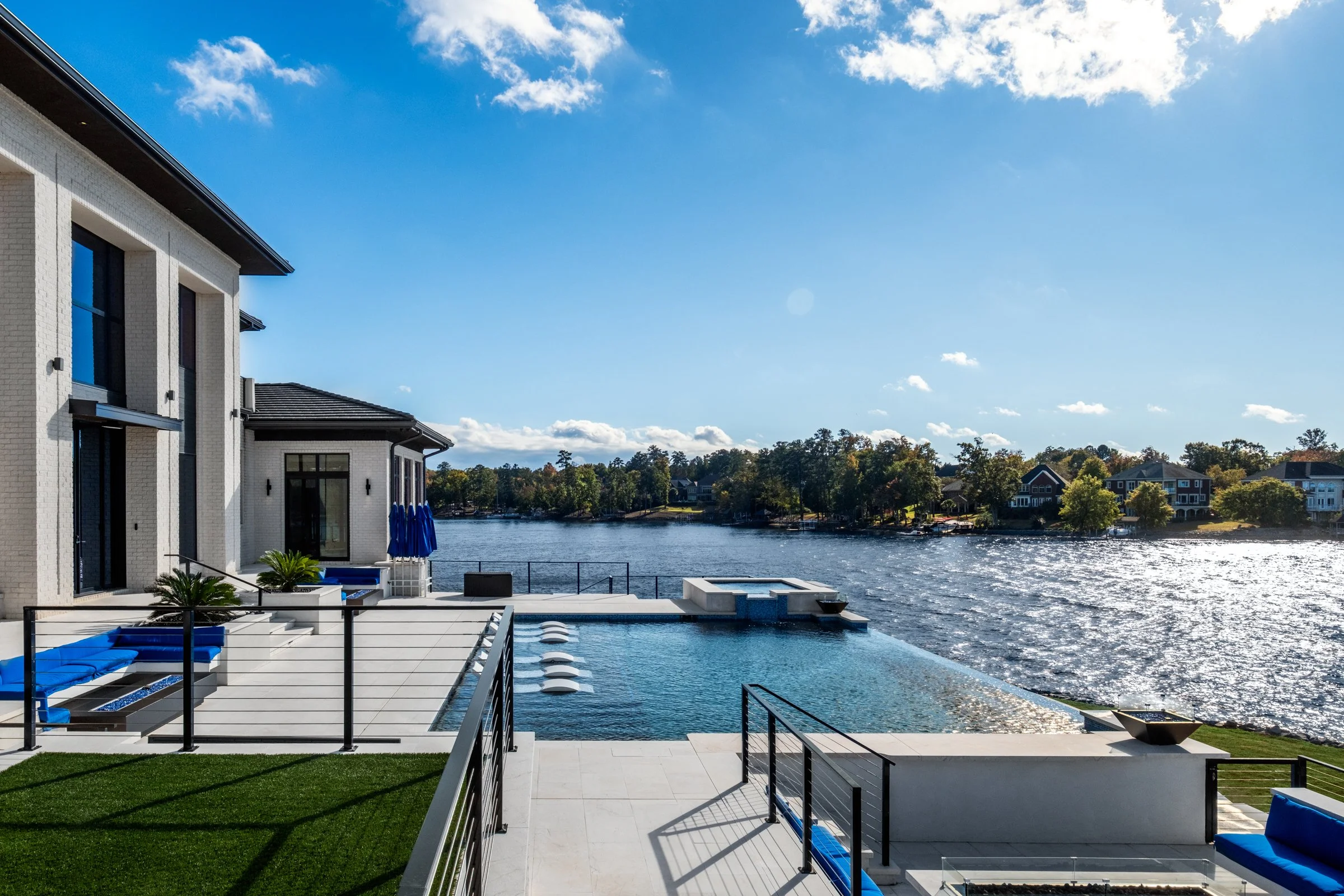 Architectural and interior photography of a customized lakefront home, highlighting design detail, atmosphere, infinity pool, and craftsmanship.