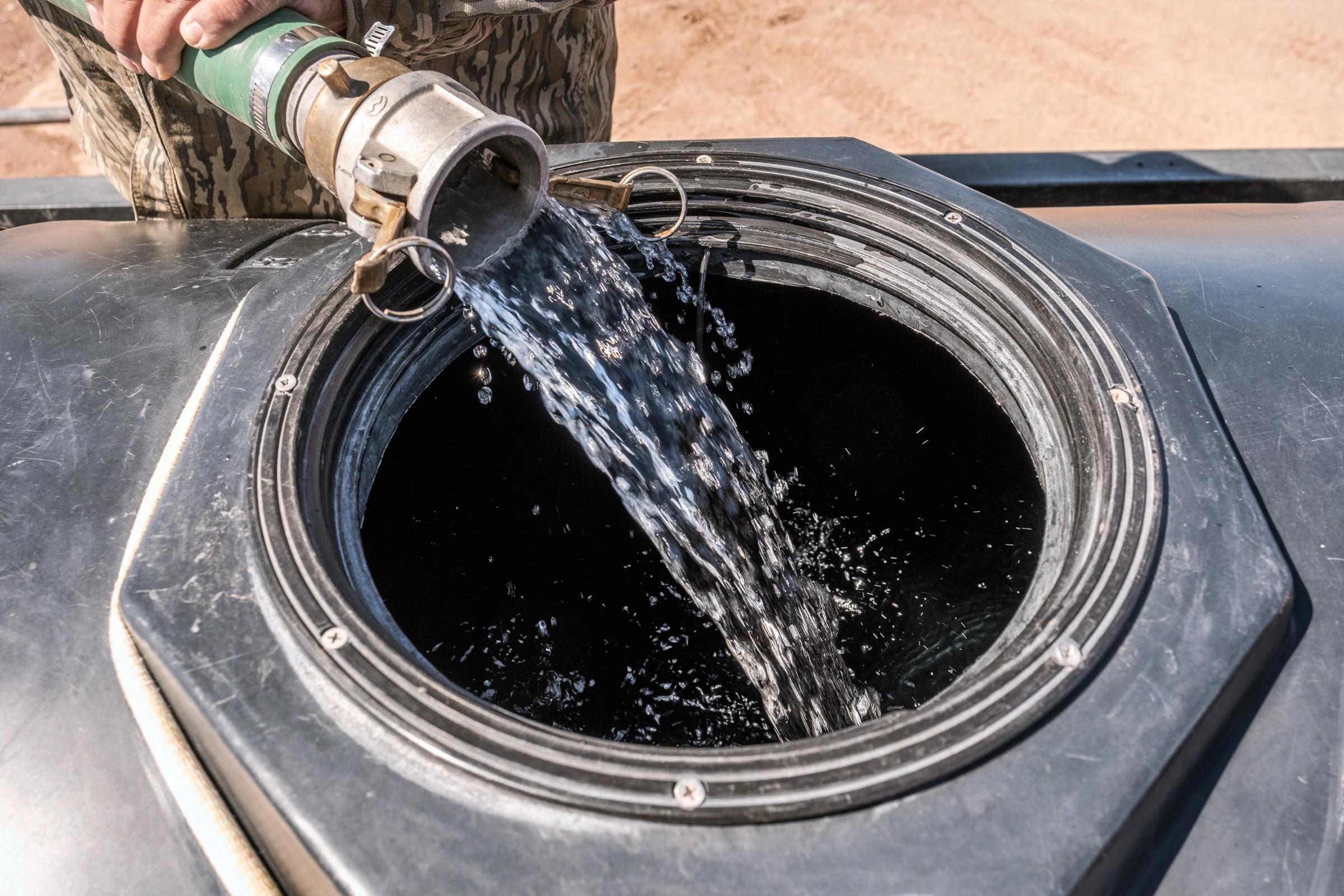 Hauling Life | Navajo Nation — Unified Metadata Paragraphs

Wayne Wilson and Joann Whiting collect water in Gallup, New Mexico at a community water source. The containers are filled, prepared, and loaded into their vehicle for transport across the Na