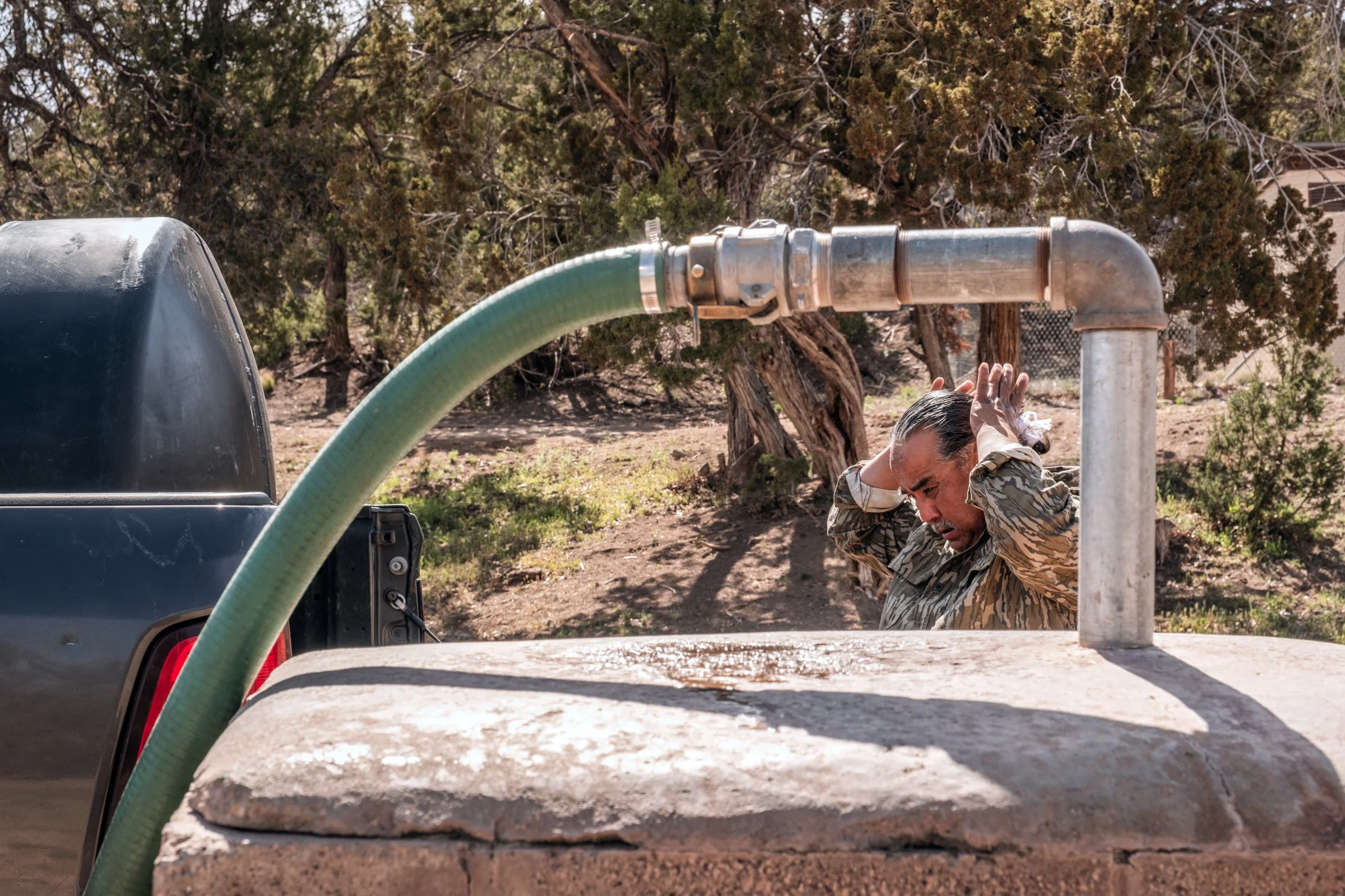 Hauling Life | Navajo Nation — Unified Metadata Paragraphs

Wayne Wilson and Joann Whiting collect water in Gallup, New Mexico at a community water source. The containers are filled, prepared, and loaded into their vehicle for transport across the Na