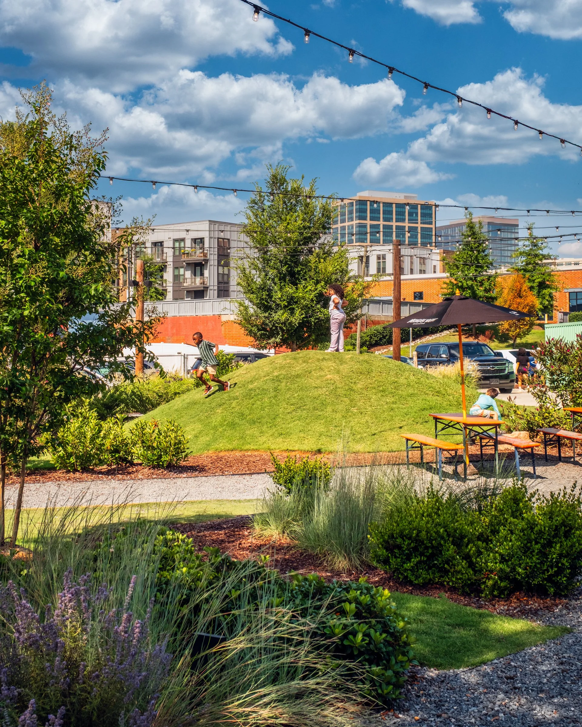 Professional photography highlighting the landscape architecture, brewery ambiance, and outdoor gathering spaces at Monday Night Brewing Charlotte.