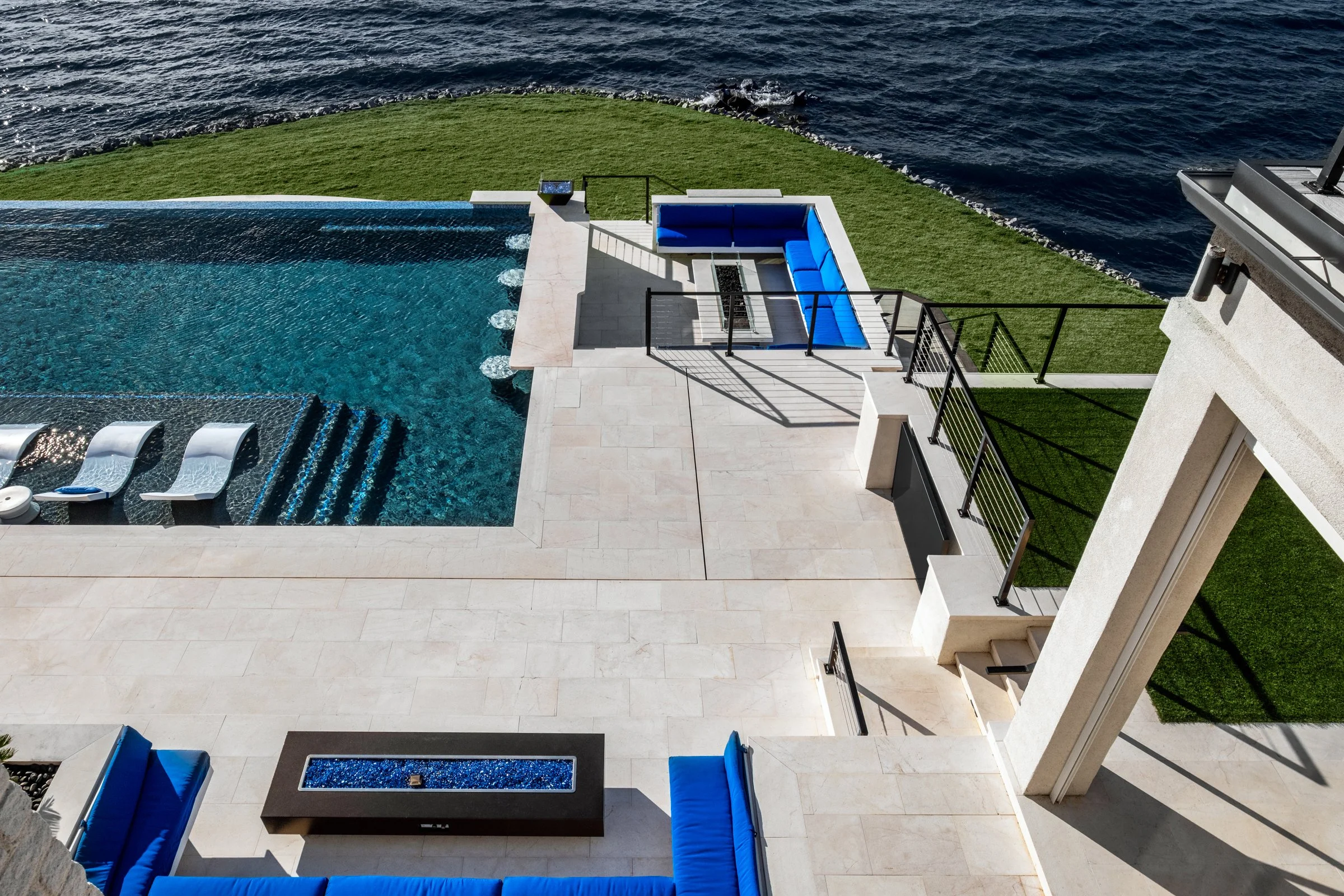 Architectural and interior photography of a customized lakefront home, highlighting design detail, atmosphere, infinity pool, and craftsmanship.