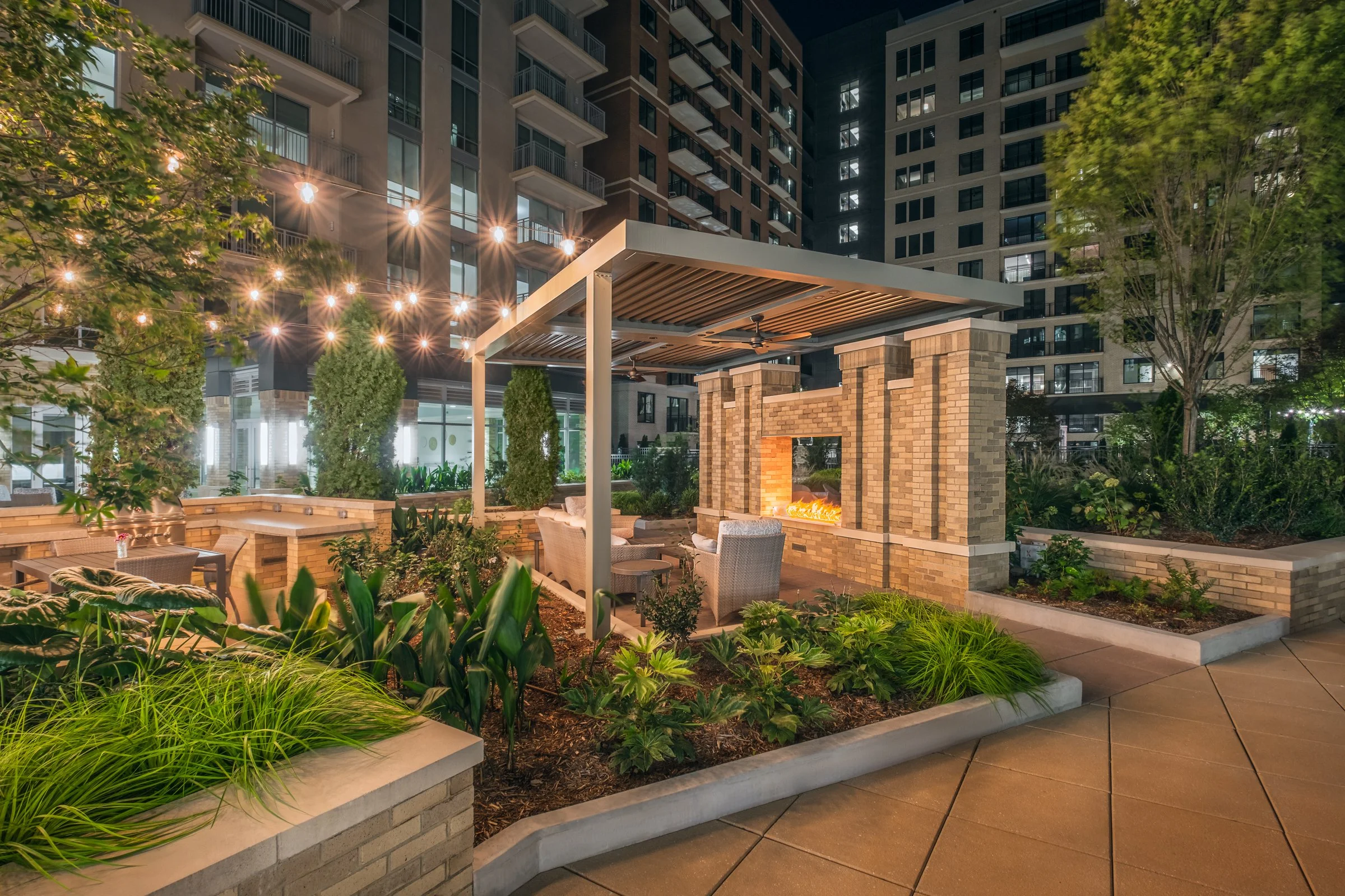 Stunning Courtyard of Village on Morehead featuring modern landscaping, seating areas, and architectural lighting