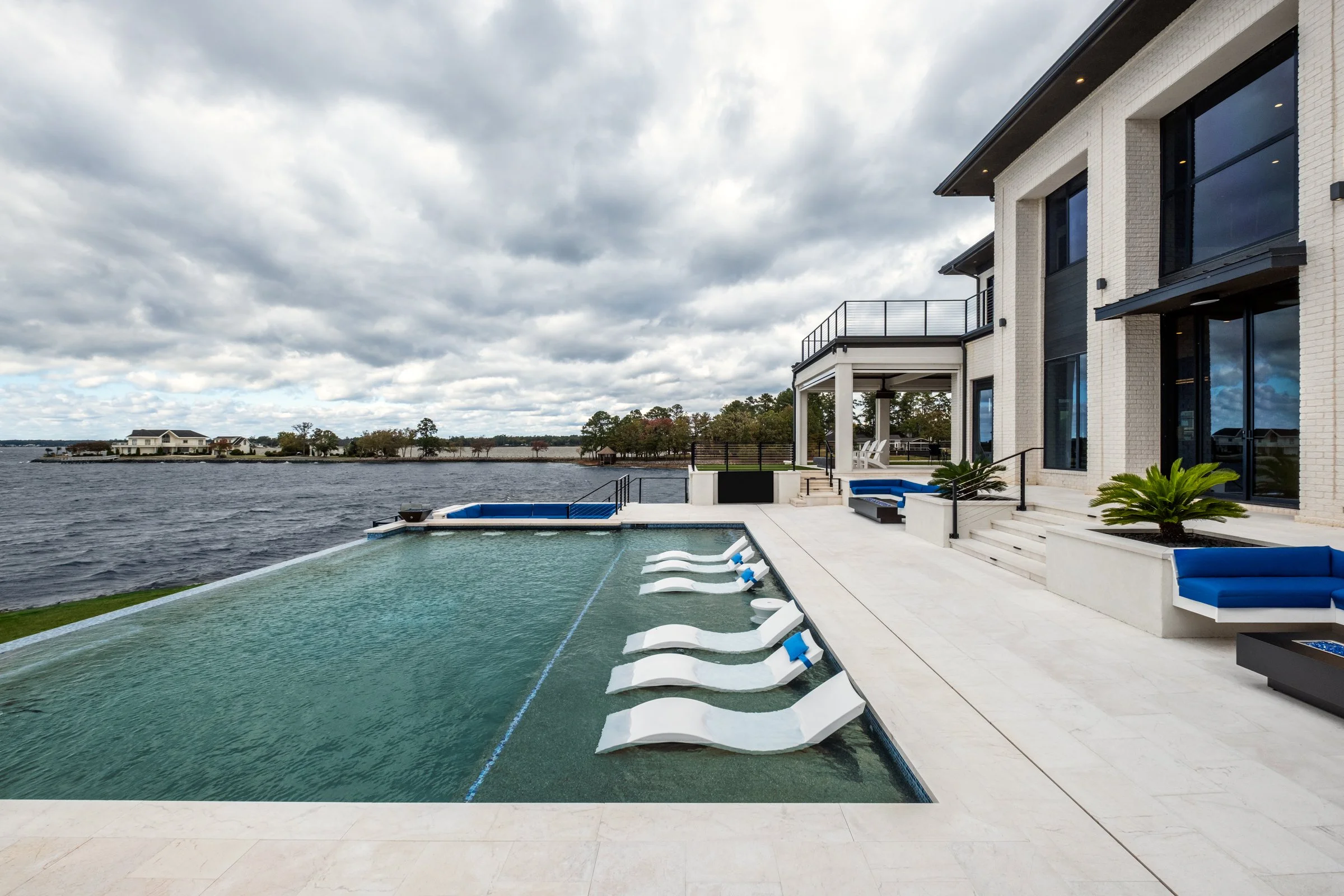 Architectural and interior photography of a customized lakefront home, highlighting design detail, atmosphere, infinity pool, and craftsmanship.