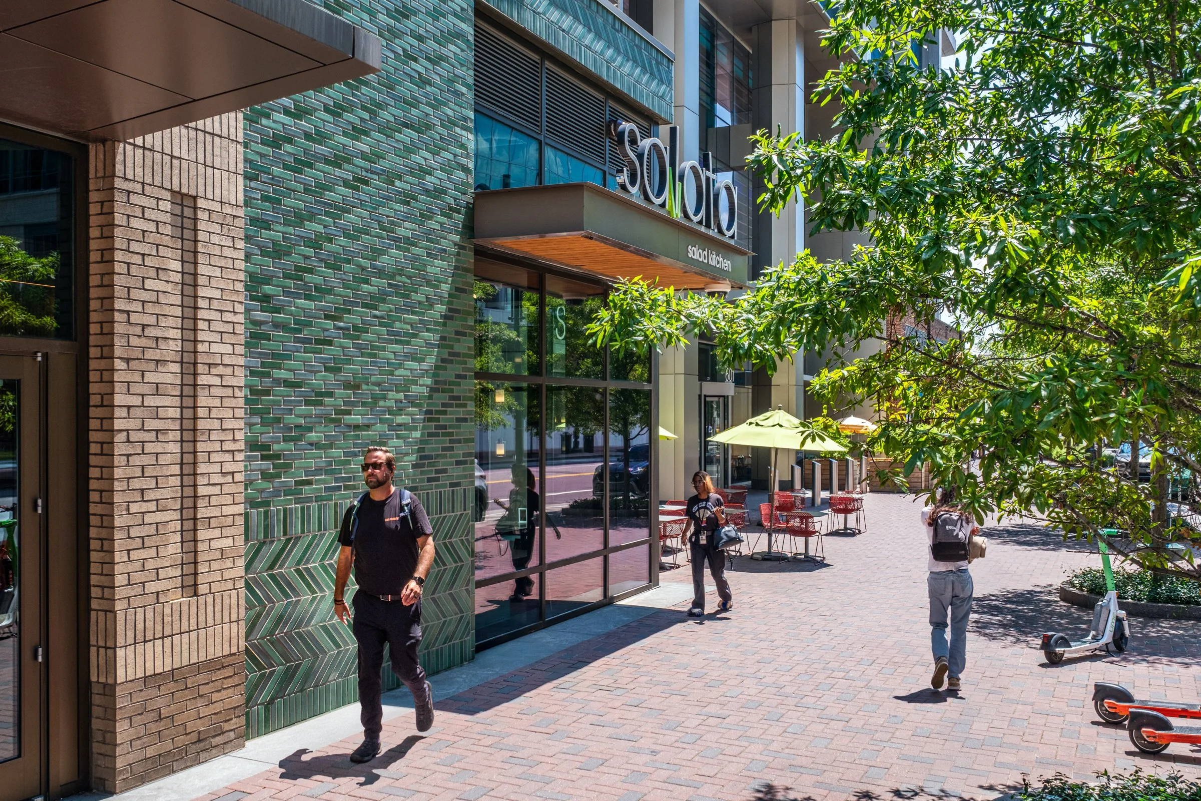 Daytime exterior view of Ally Charlotte Center, highlighting its modern architecture and urban setting in Uptown Charlotte.”