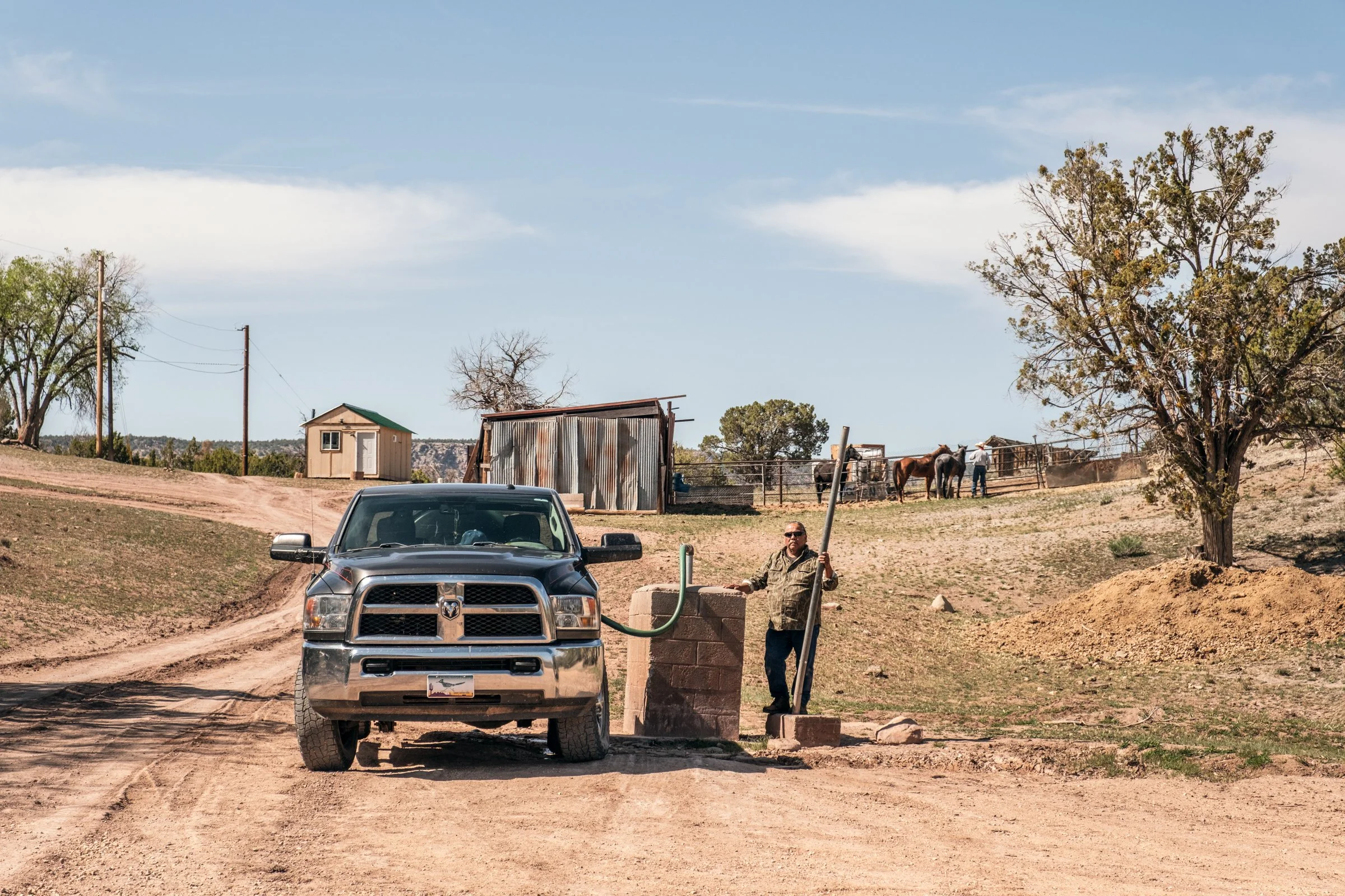 Hauling Life | Navajo Nation — Unified Metadata Paragraphs

Wayne Wilson and Joann Whiting collect water in Gallup, New Mexico at a community water source. The containers are filled, prepared, and loaded into their vehicle for transport across the Na