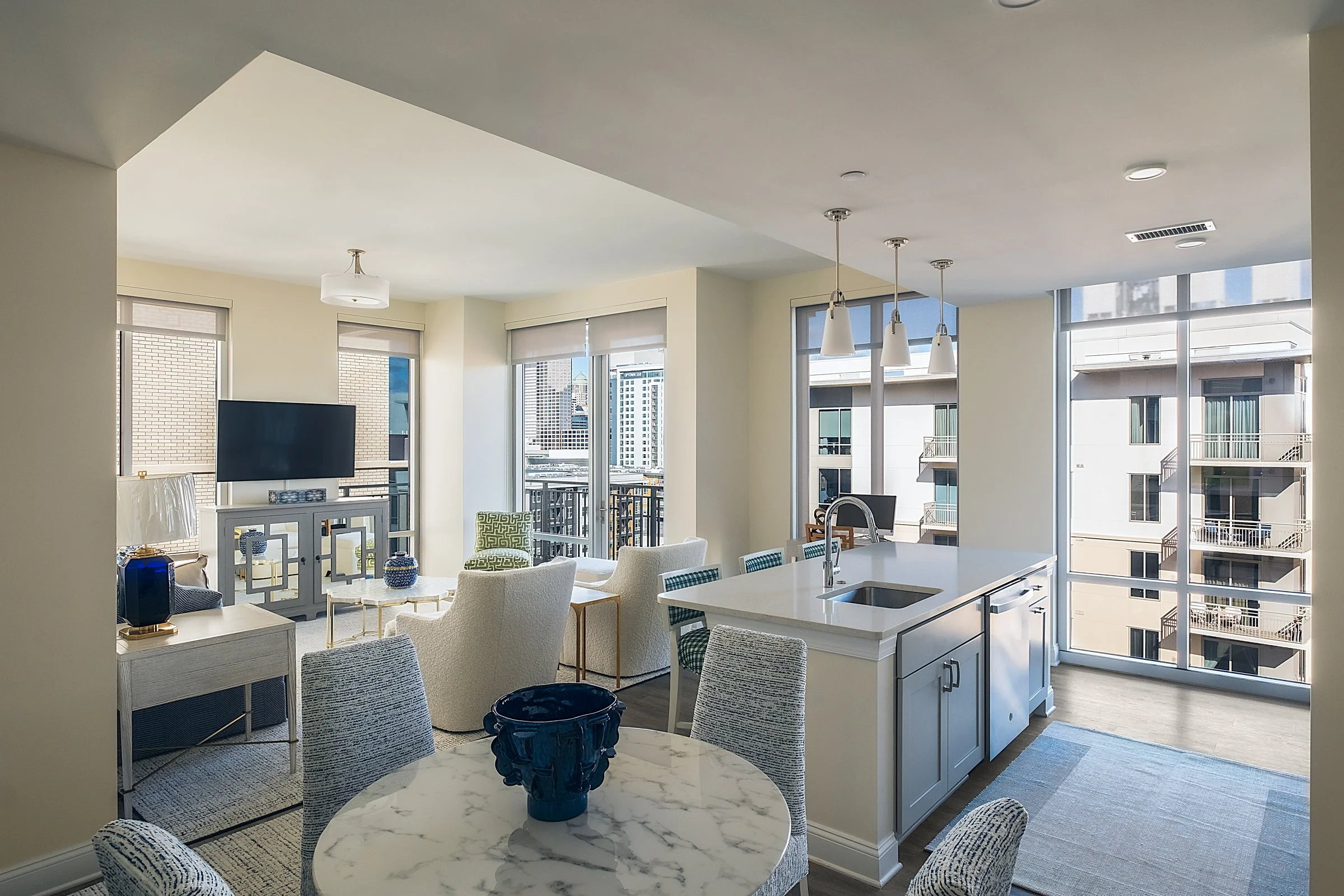 Open concept dining and entertainment space in Village on Morehead unit highlighting contemporary design elements