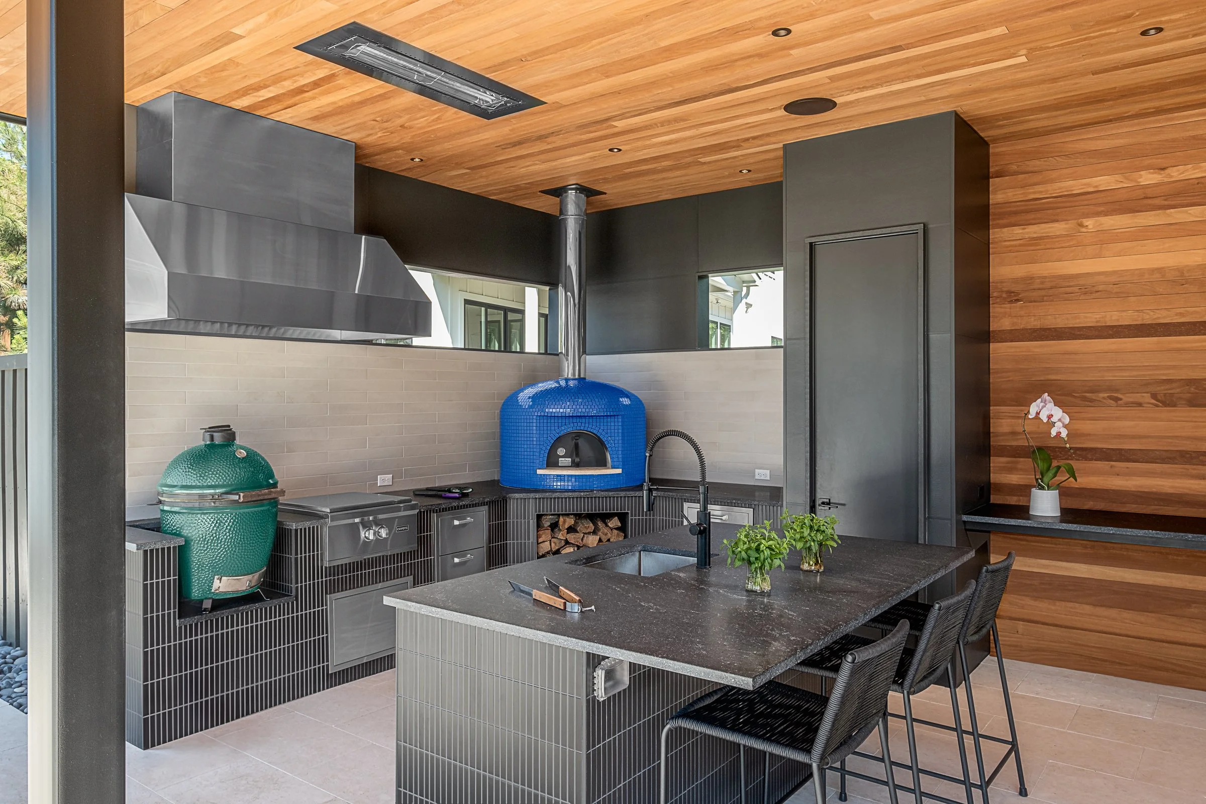 Modern pool pavilion architecture featuring clean lines, natural materials, and seamless indoor-outdoor living spaces in Charlotte, North Carolina. This contemporary structure showcases floor-to-ceiling glass walls, exposed wooden beams, and a minima
