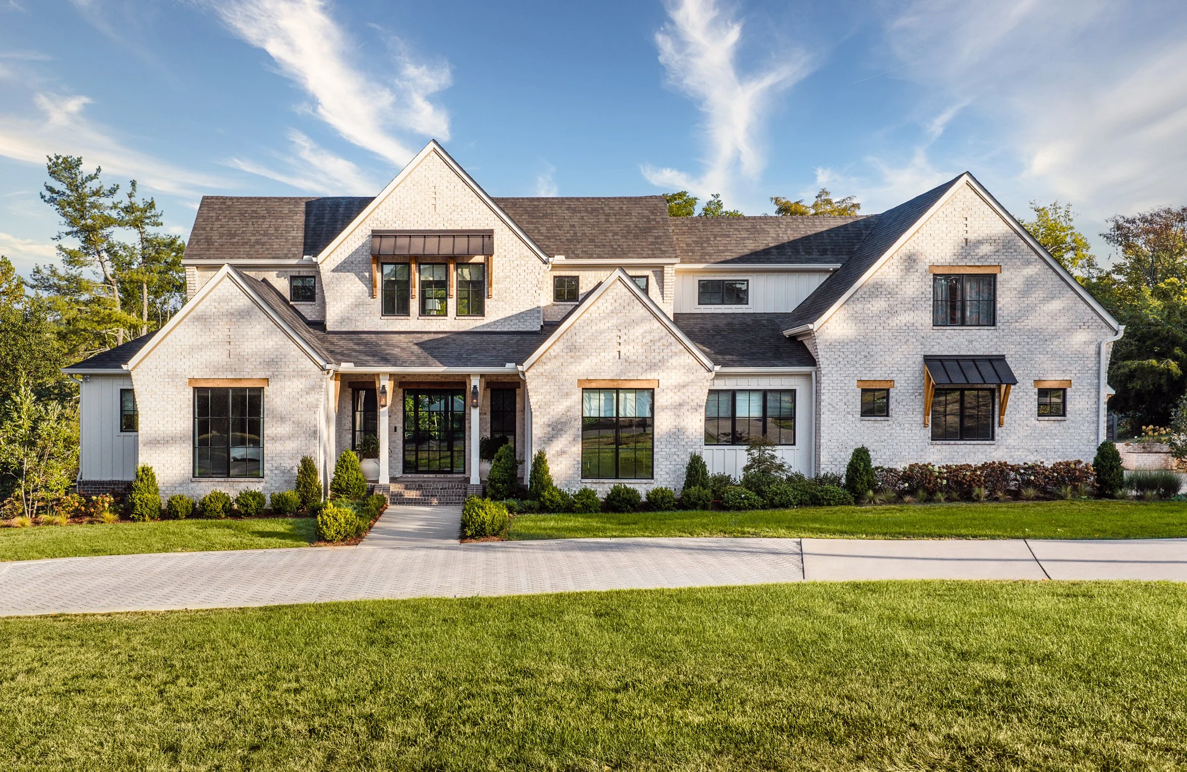 Architectural and interior photography of a custom home in Nashville, Tennessee, designed by Origin Architecture and photographed by Paul Lange of Lange Photo Studio. Warm light from the home’s fixtures highlights thoughtful architectural details and