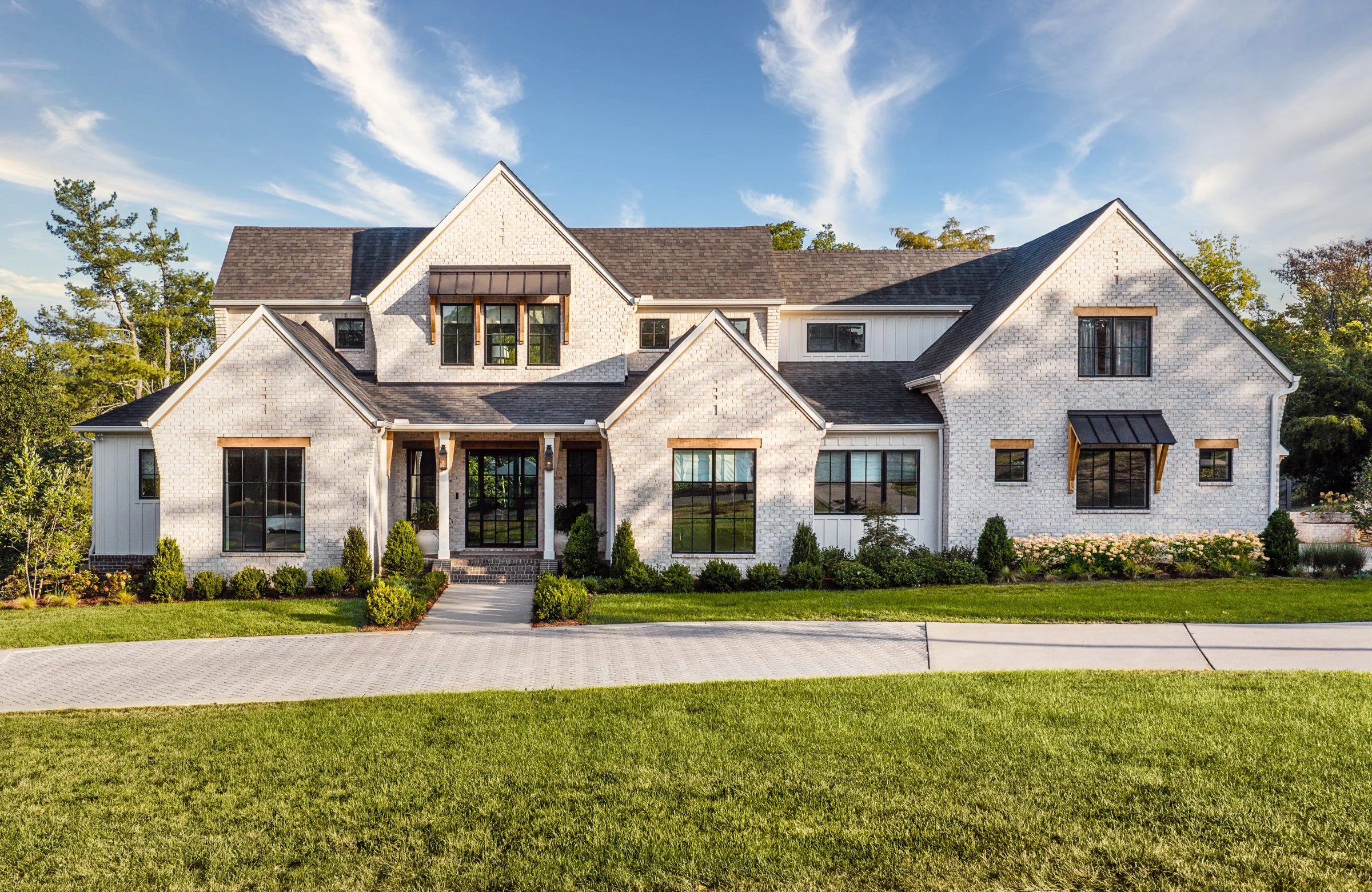 Architectural and interior photography of a custom home in Nashville, Tennessee, designed by Origin Architecture and photographed by Paul Lange of Lange Photo Studio. Warm light from the home’s fixtures highlights thoughtful architectural details and