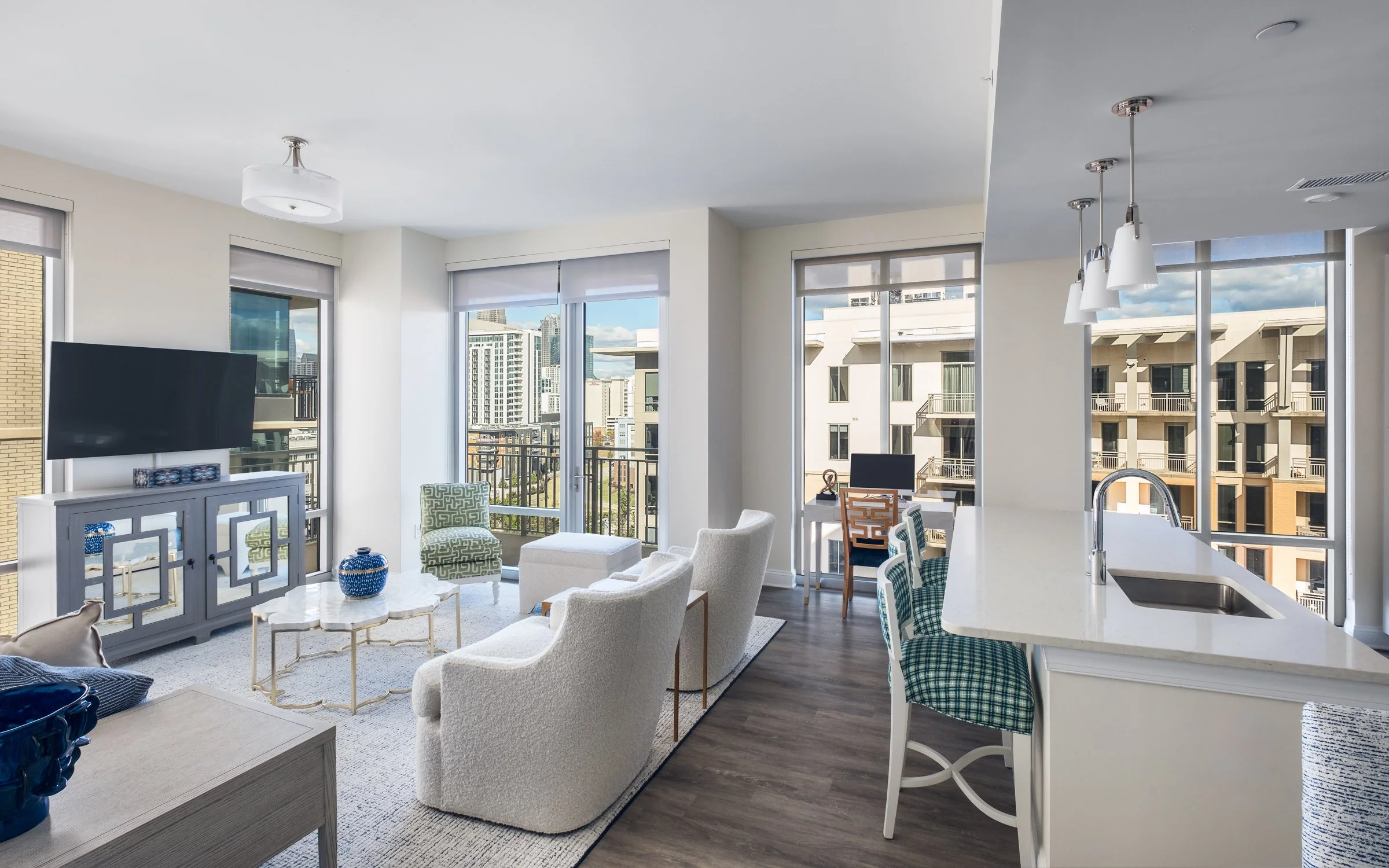Open concept dining and entertainment space in Village on Morehead unit highlighting contemporary design elements