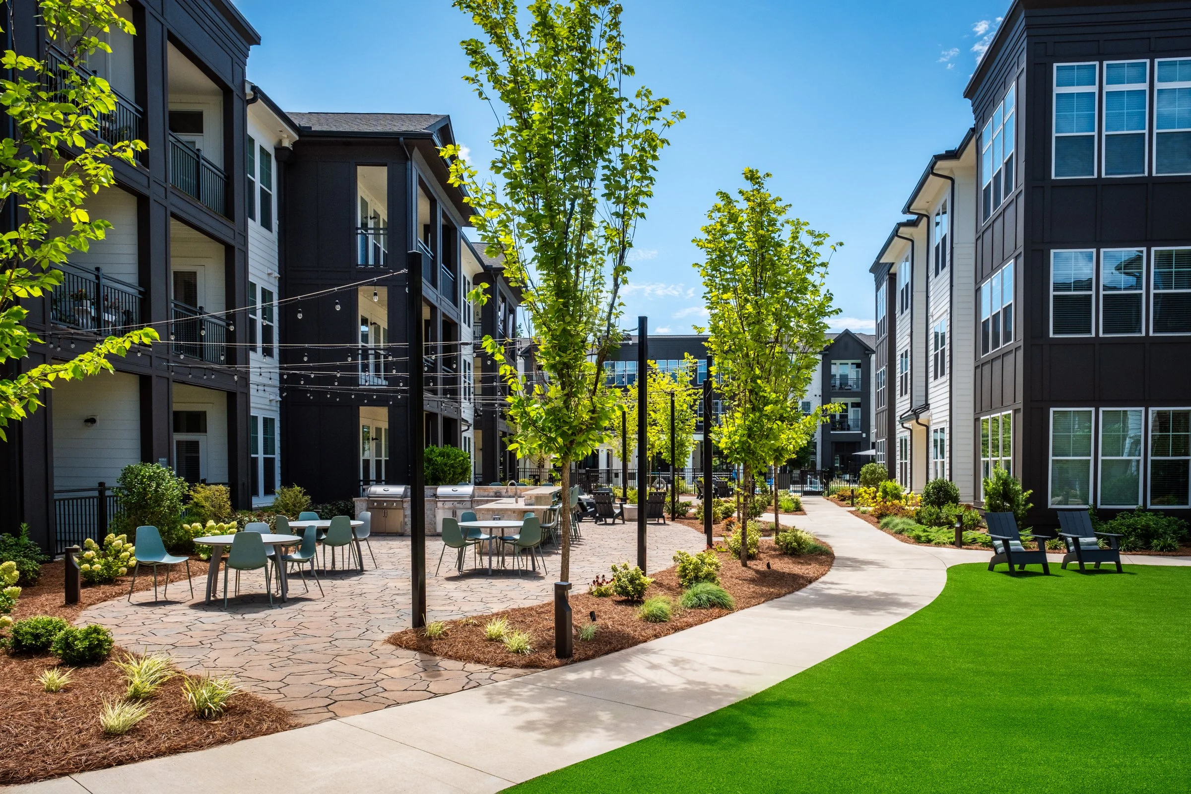 Connery on Providence 55+ community pool and adjacent amenity space, showcasing photography landscape design and seating areas, Charlotte, NC. Created by Lange Photo Studio. 