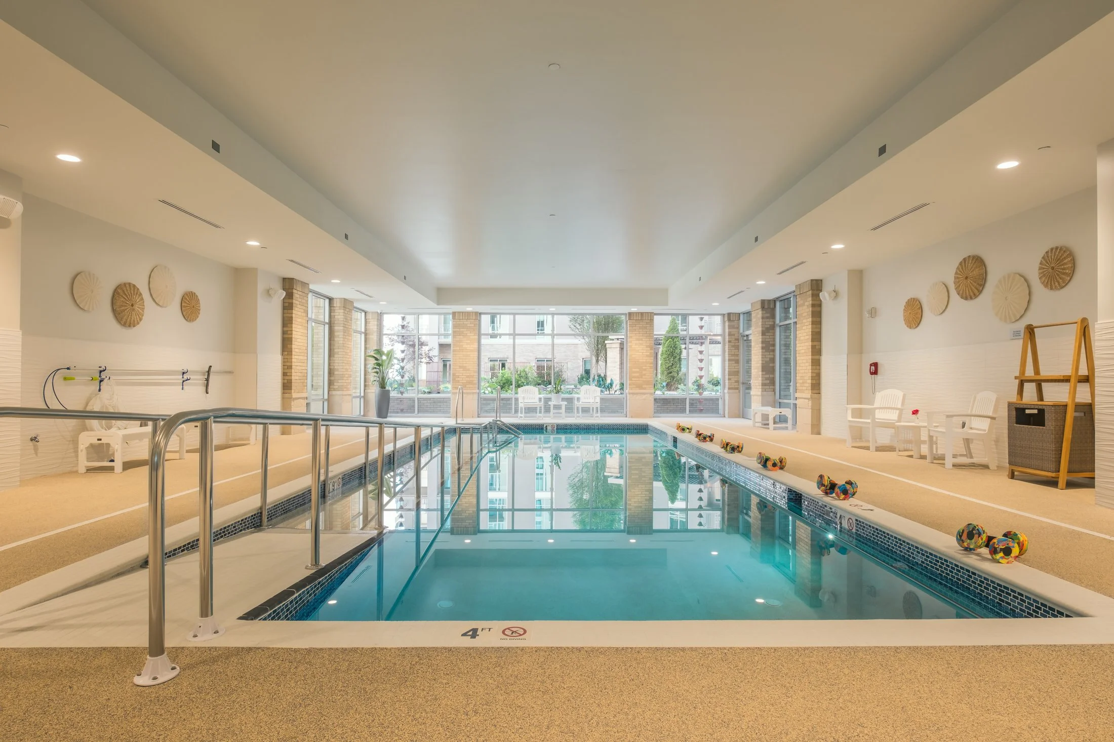 Beautiful pool in Village on Morehead residence with custom lighting fixtures and lot of natural light.