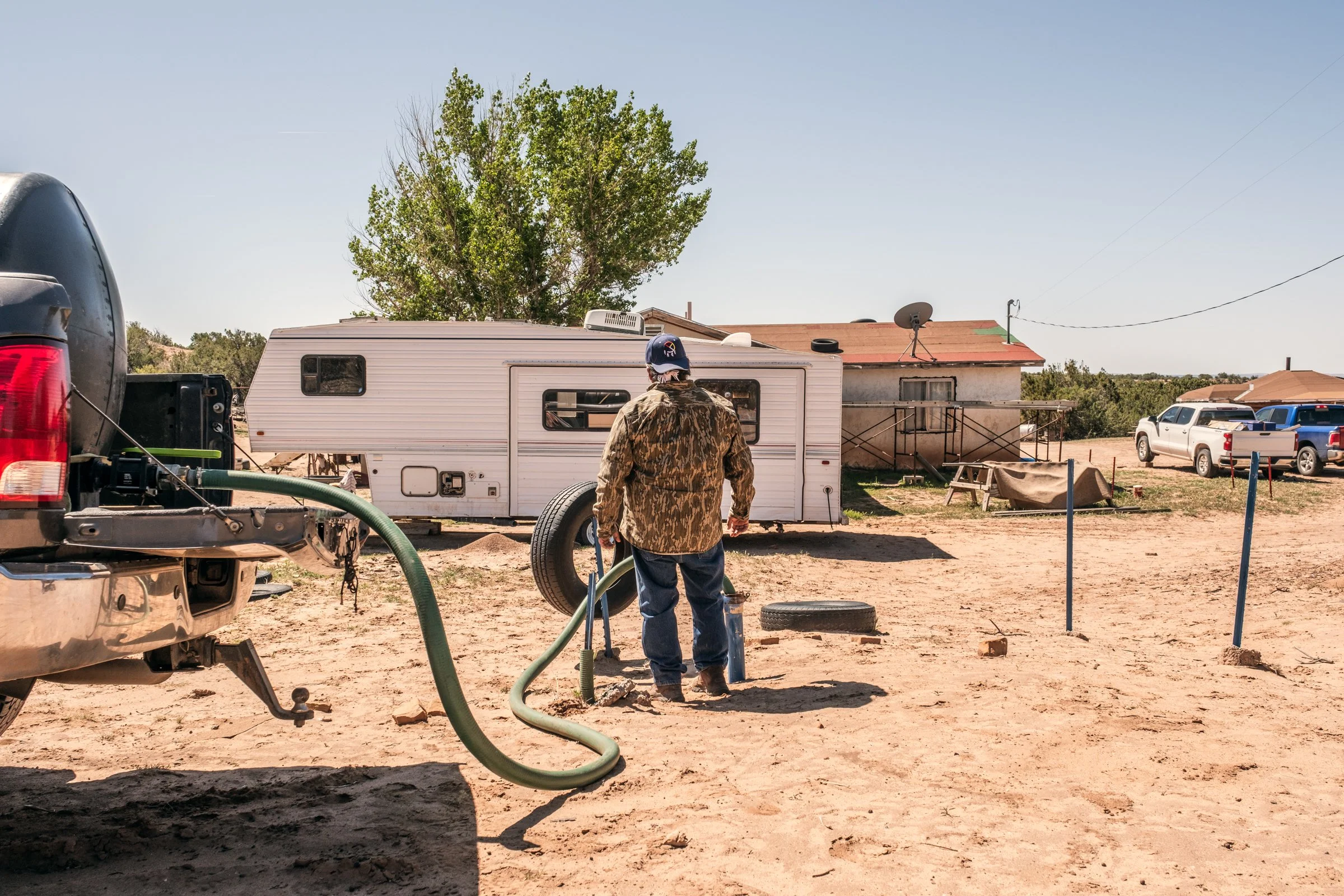 Hauling Life | Navajo Nation — Unified Metadata Paragraphs

Wayne Wilson and Joann Whiting collect water in Gallup, New Mexico at a community water source. The containers are filled, prepared, and loaded into their vehicle for transport across the Na