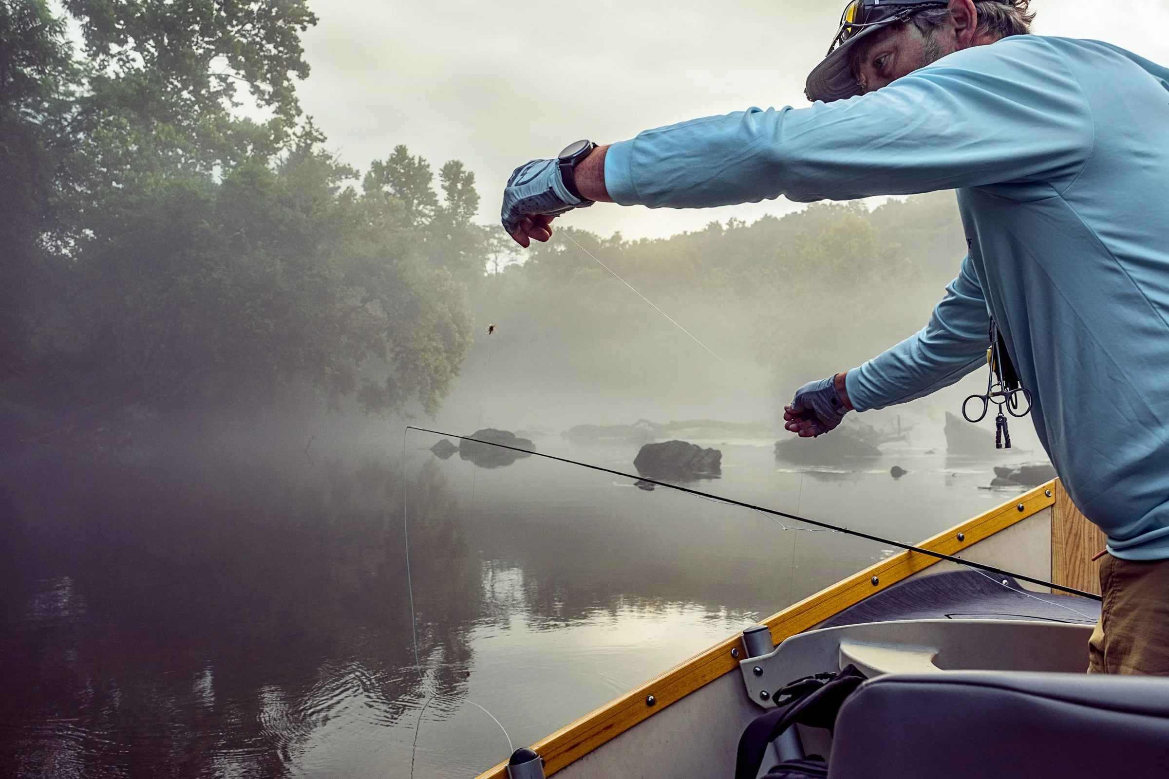 Guided fly fishing trip with Asheville Fly Fishing Company on a foggy river near Asheville, North Carolina. Photographed by Lange Photo Studio.