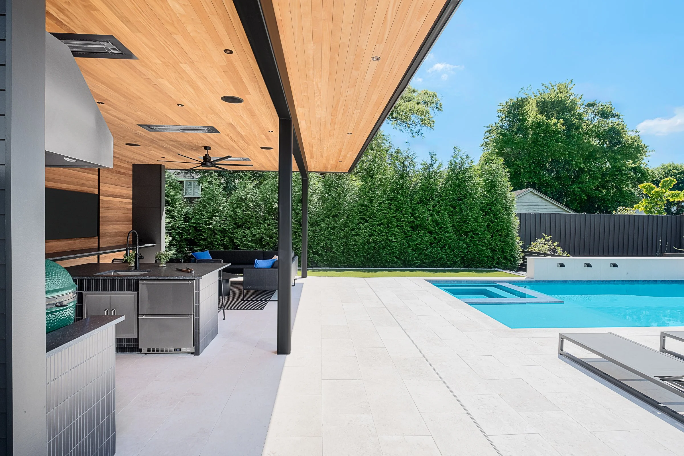 Modern pool pavilion architecture featuring clean lines, natural materials, and seamless indoor-outdoor living spaces in Charlotte, North Carolina. This contemporary structure showcases floor-to-ceiling glass walls, exposed wooden beams, and a minima