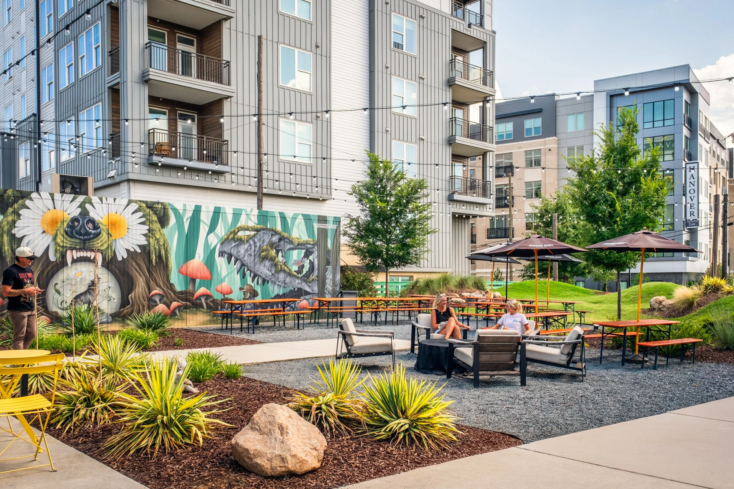 Professional photography highlighting the landscape architecture, brewery ambiance, and outdoor gathering spaces at Monday Night Brewing Charlotte.