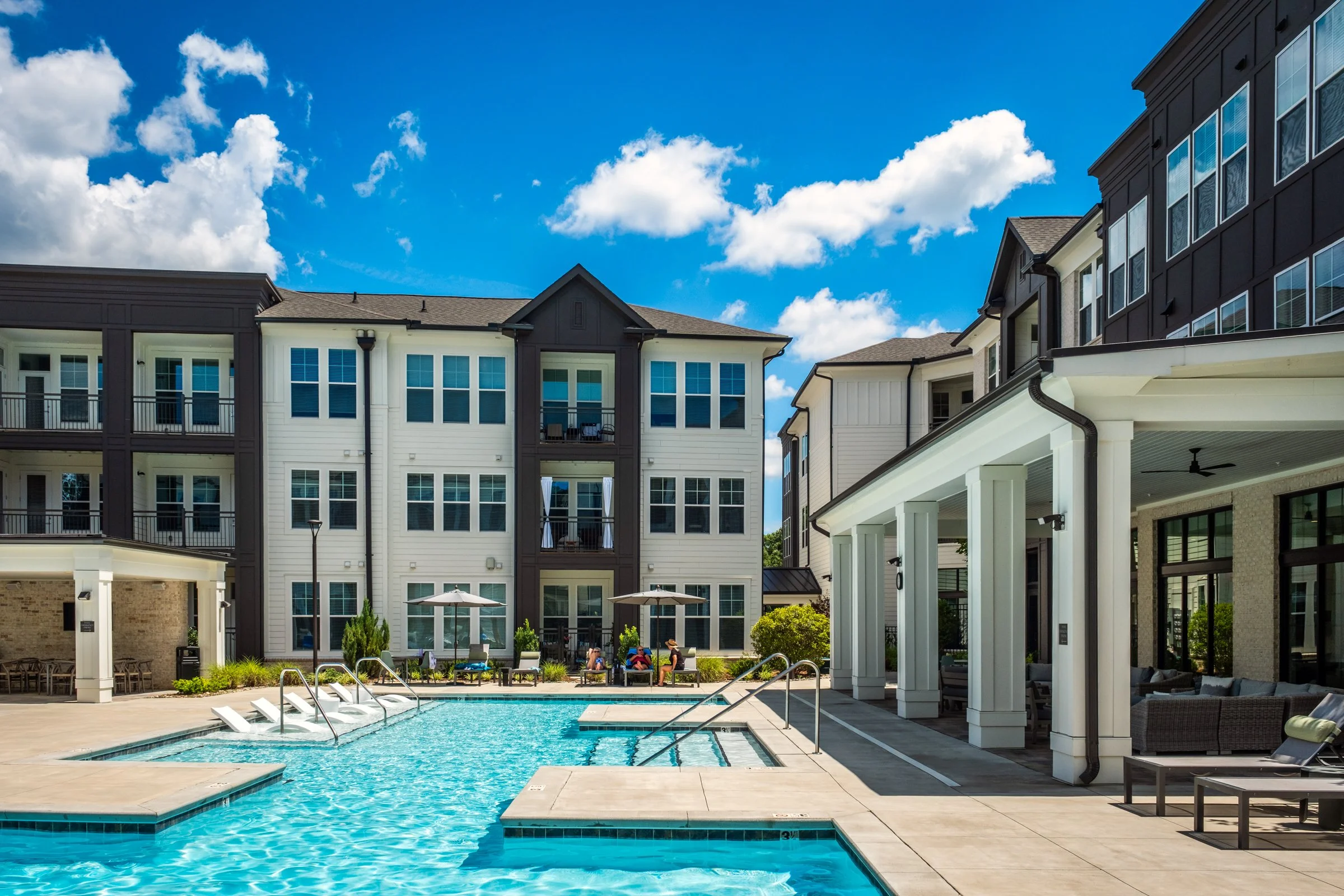 Connery on Providence 55+ community pool and adjacent amenity space, showcasing photography landscape design and seating areas, Charlotte, NC. Created by Lange Photo Studio. 