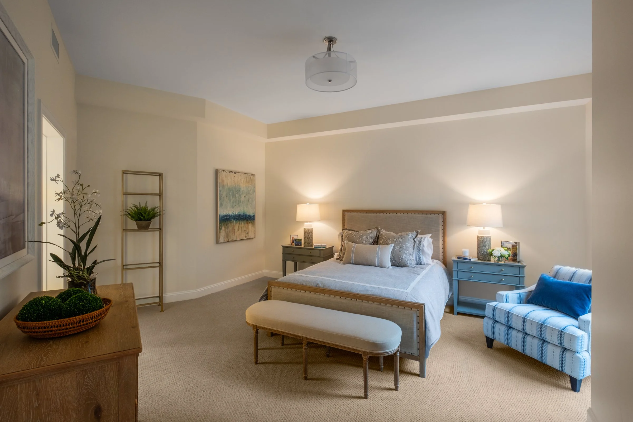 Minimalist bedroom design in Village on Morehead residence with custom lighting fixtures and beautiful flooring. 