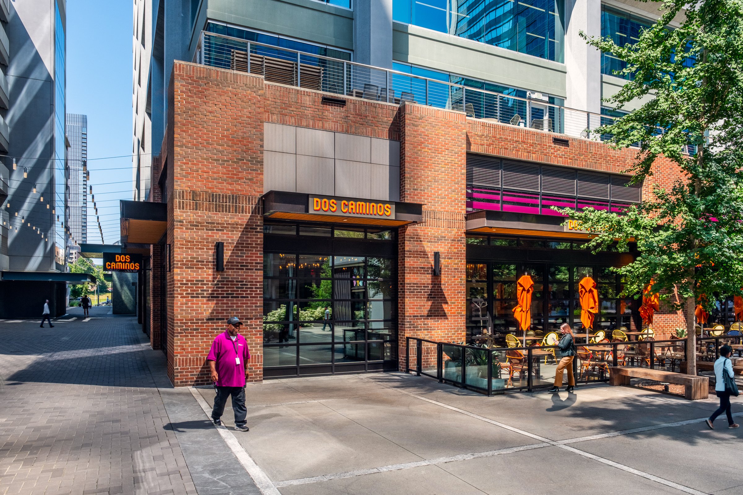 Daytime exterior view of Ally Charlotte Center, highlighting its modern architecture and urban setting in Uptown Charlotte.”