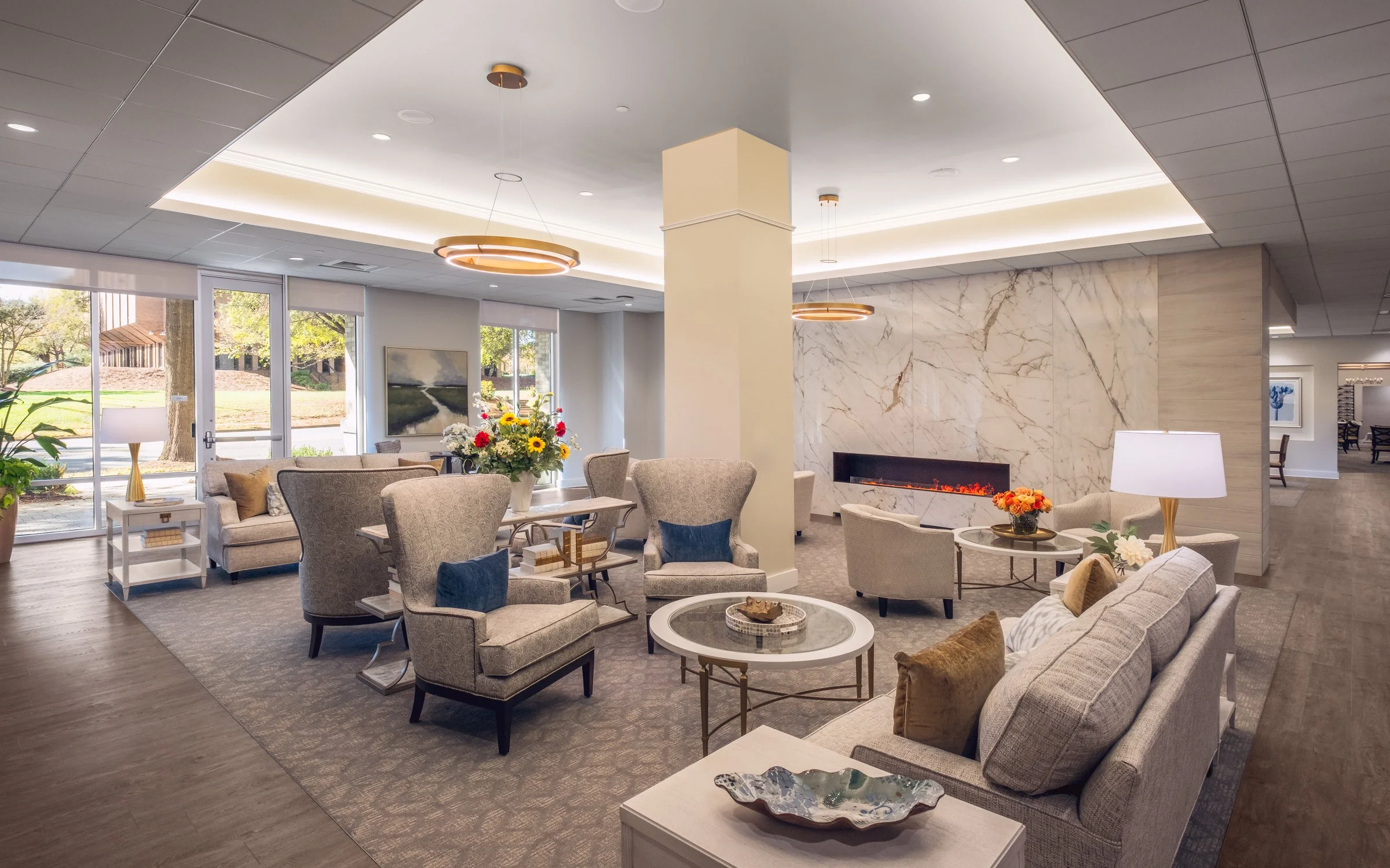 Spacious modern interior lobby of Village on Morehead featuring natural light, contemporary furniture, and architectural details
