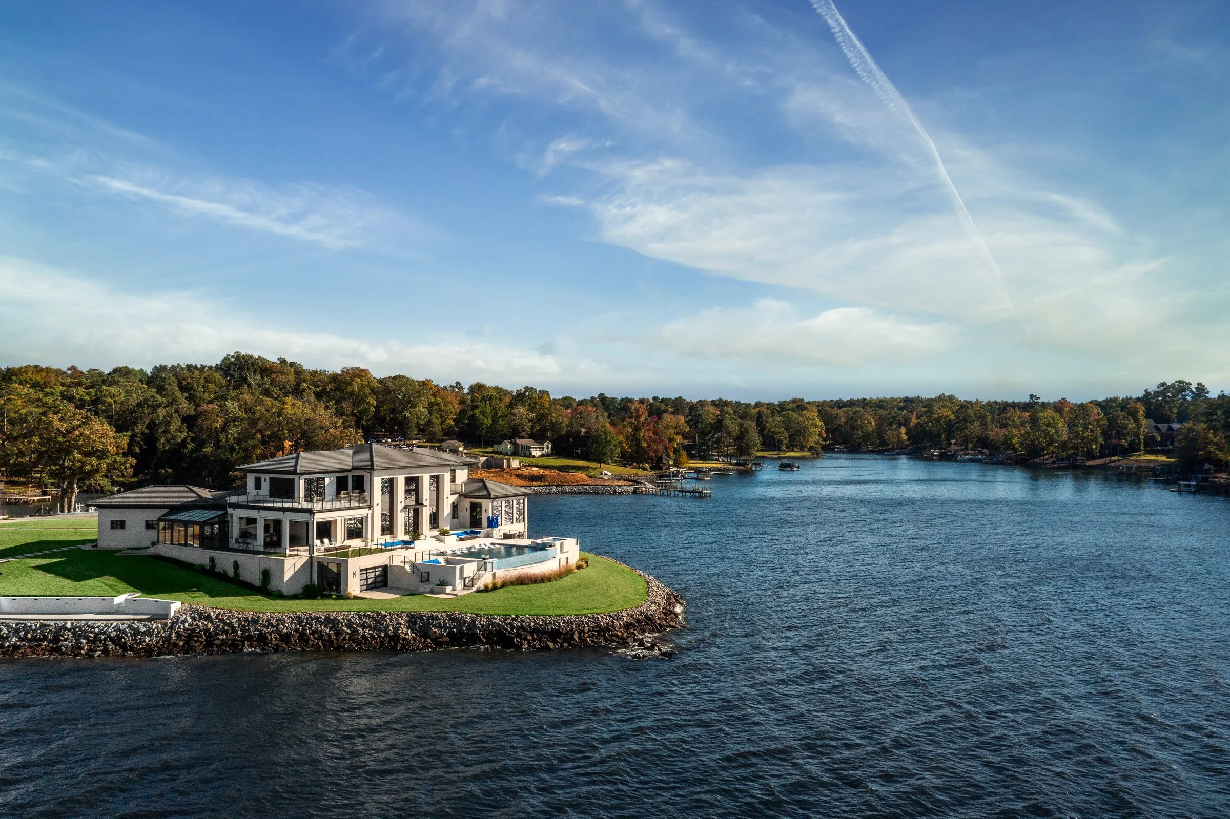 Architectural and interior photography of a customized lakefront home, highlighting design detail, atmosphere, infinity pool, and craftsmanship.