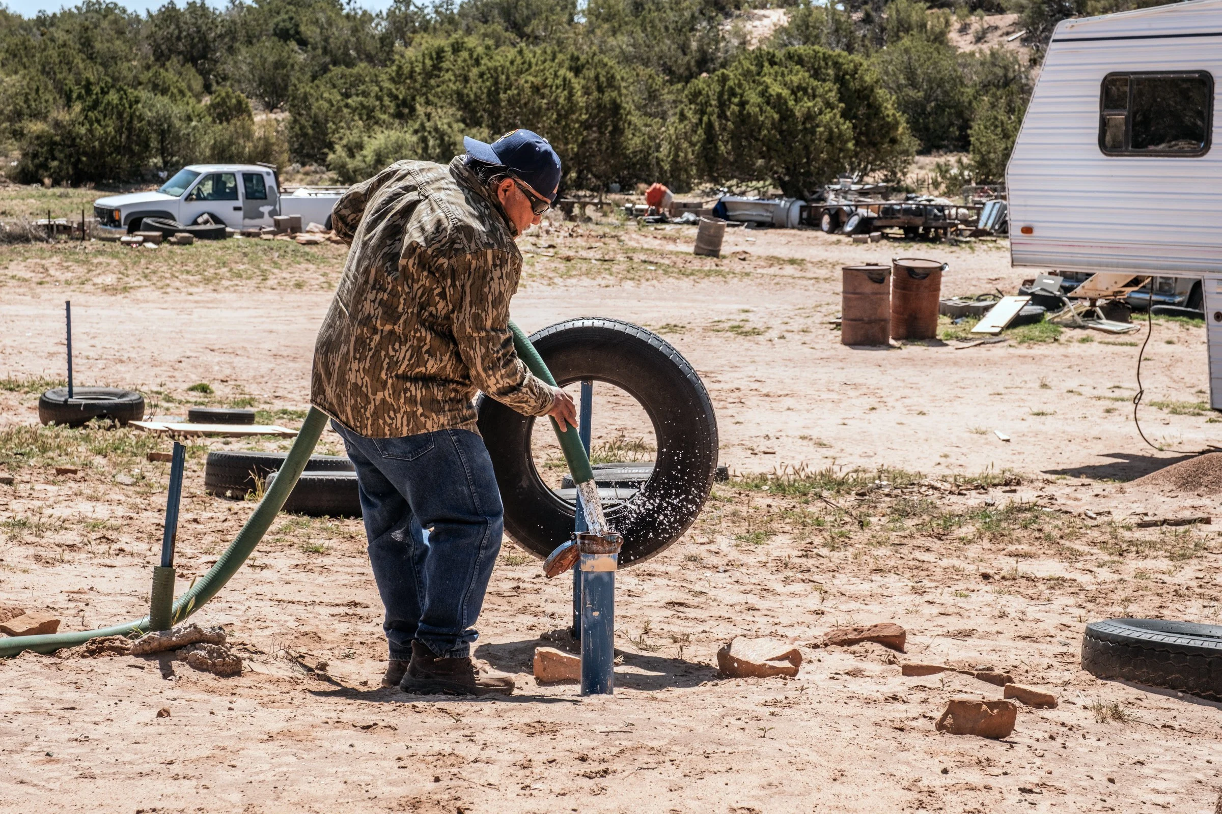 Hauling Life | Navajo Nation — Unified Metadata Paragraphs

Wayne Wilson and Joann Whiting collect water in Gallup, New Mexico at a community water source. The containers are filled, prepared, and loaded into their vehicle for transport across the Na