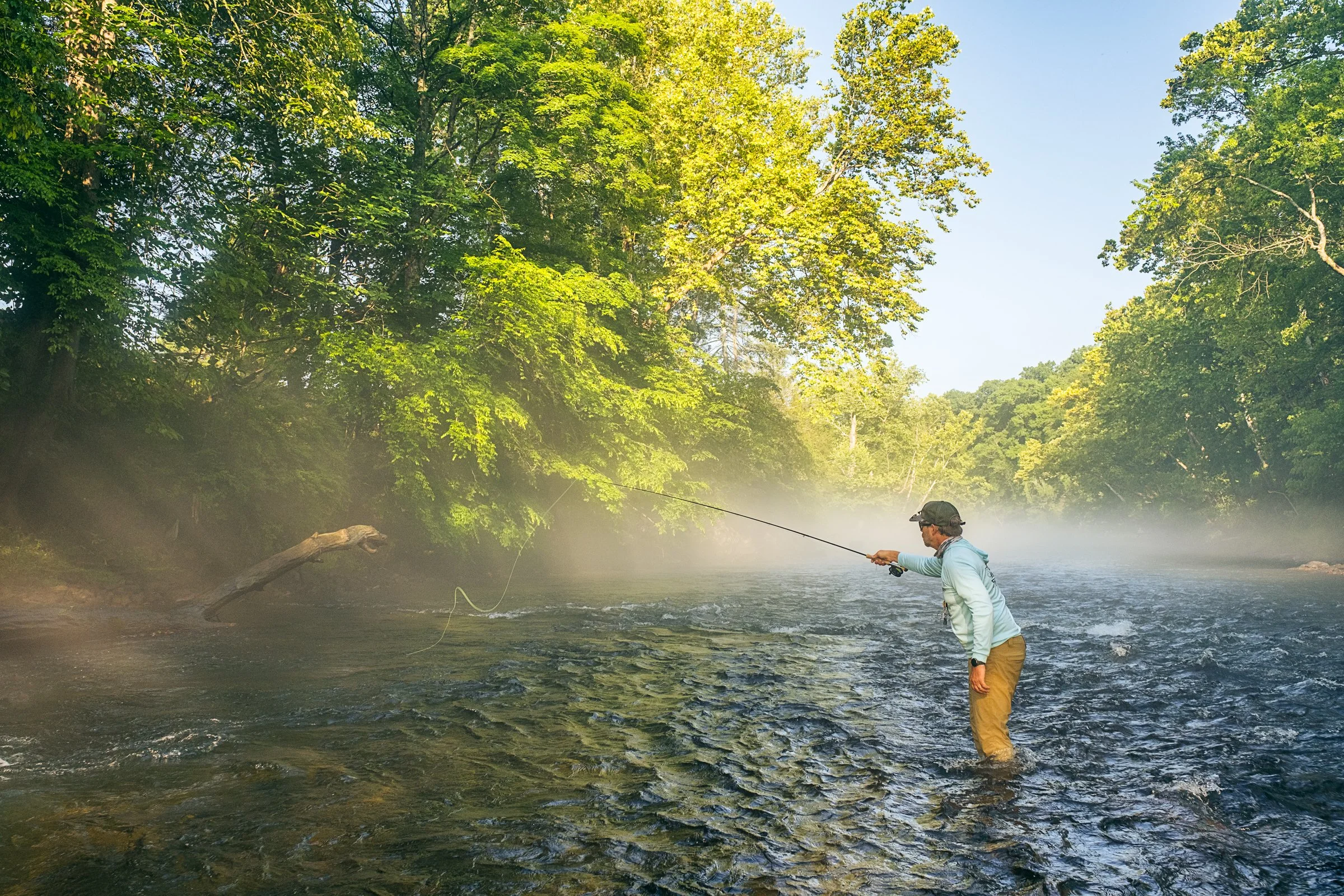 Guided fly fishing trip with Asheville Fly Fishing Company on a foggy river near Asheville, North Carolina. Photographed by Lange Photo Studio.